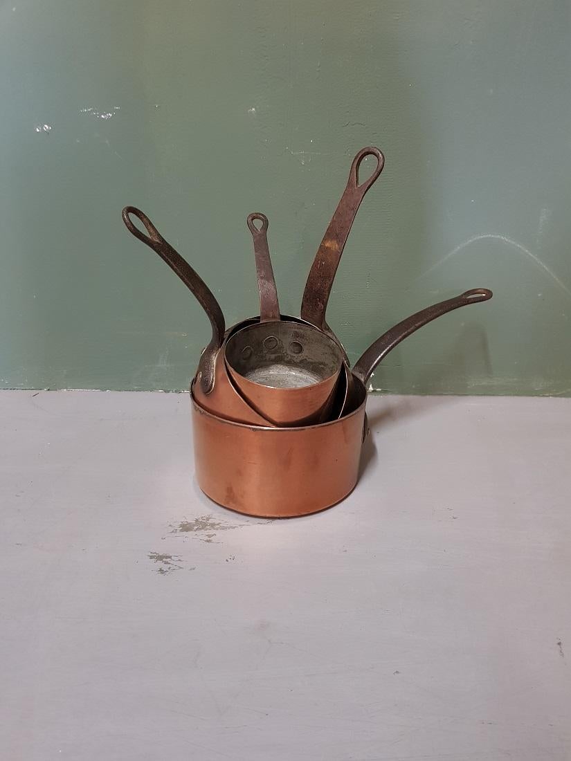 Old French 4-piece copper pan set with tinned inside and metal handles with a beautiful patina obtained by use, early 20th century. 

The measurements are,
Diameter 10.5 cm, 13 cm, 15 cm and 17 cm/ 4.1, 5.1, 5.9 and 6.6 inch.
Height 5.5 cm, 6.5