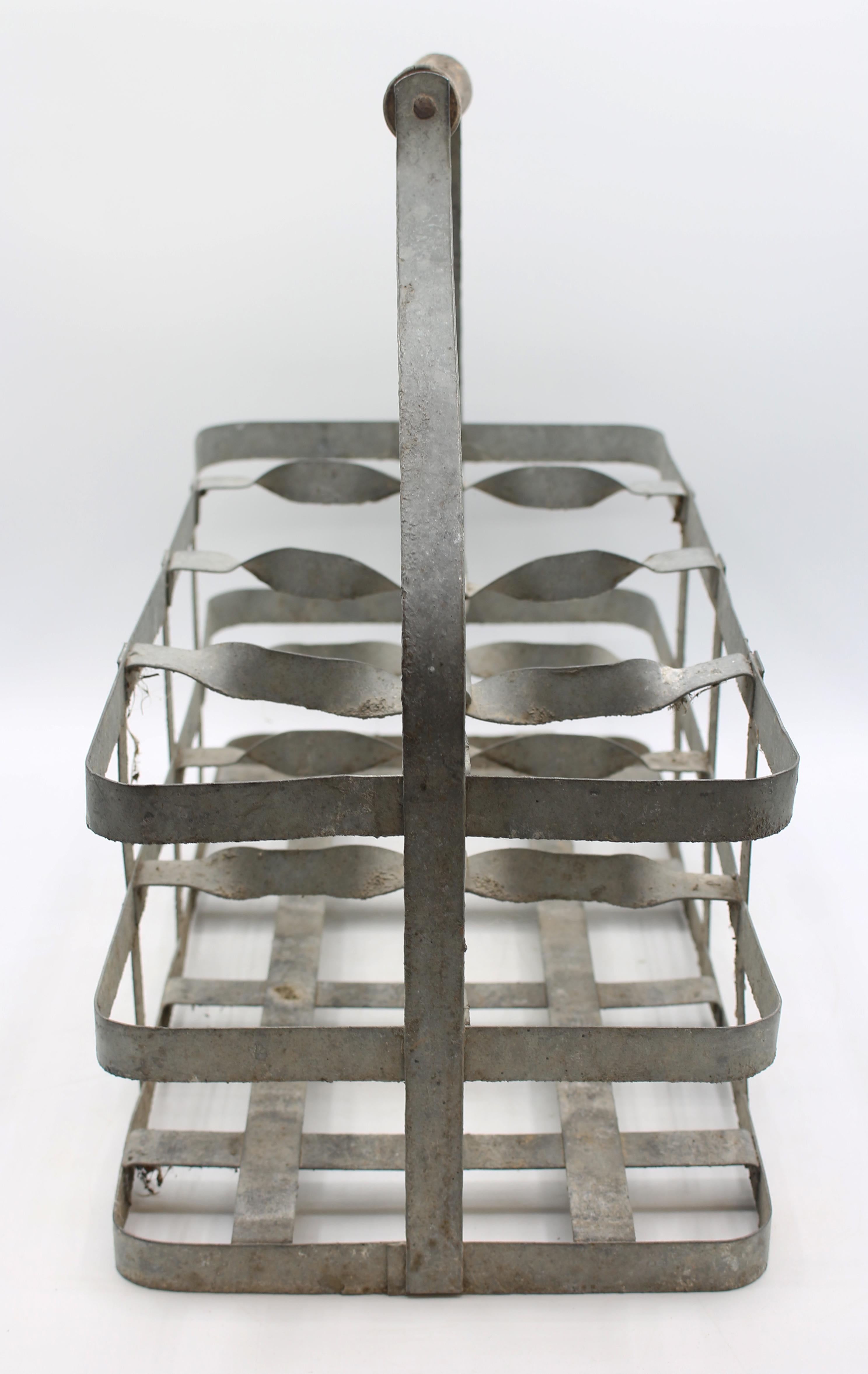 Early 20th century large French 8-bottle wine carrier. Zinc, decoratively twisted dividers, with shaped treen carrying handle.
15 7/8
