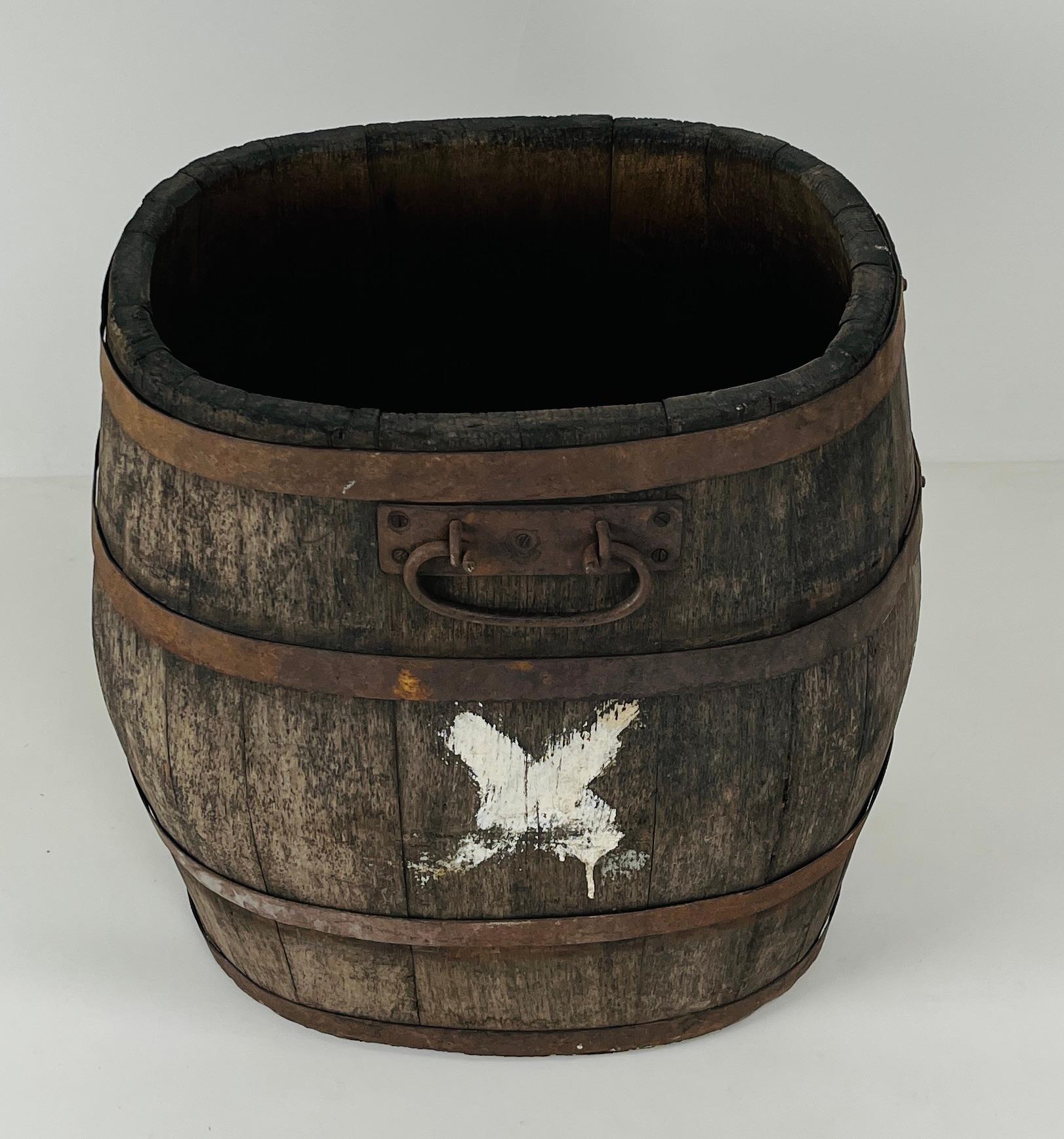 A robust and evocative apple harvesting barrel from early 20th century France, crafted in solid oak and bound with aged steel bands. This utilitarian piece speaks to the rhythms of rural life and the enduring beauty of honest materials.

•  Origin: