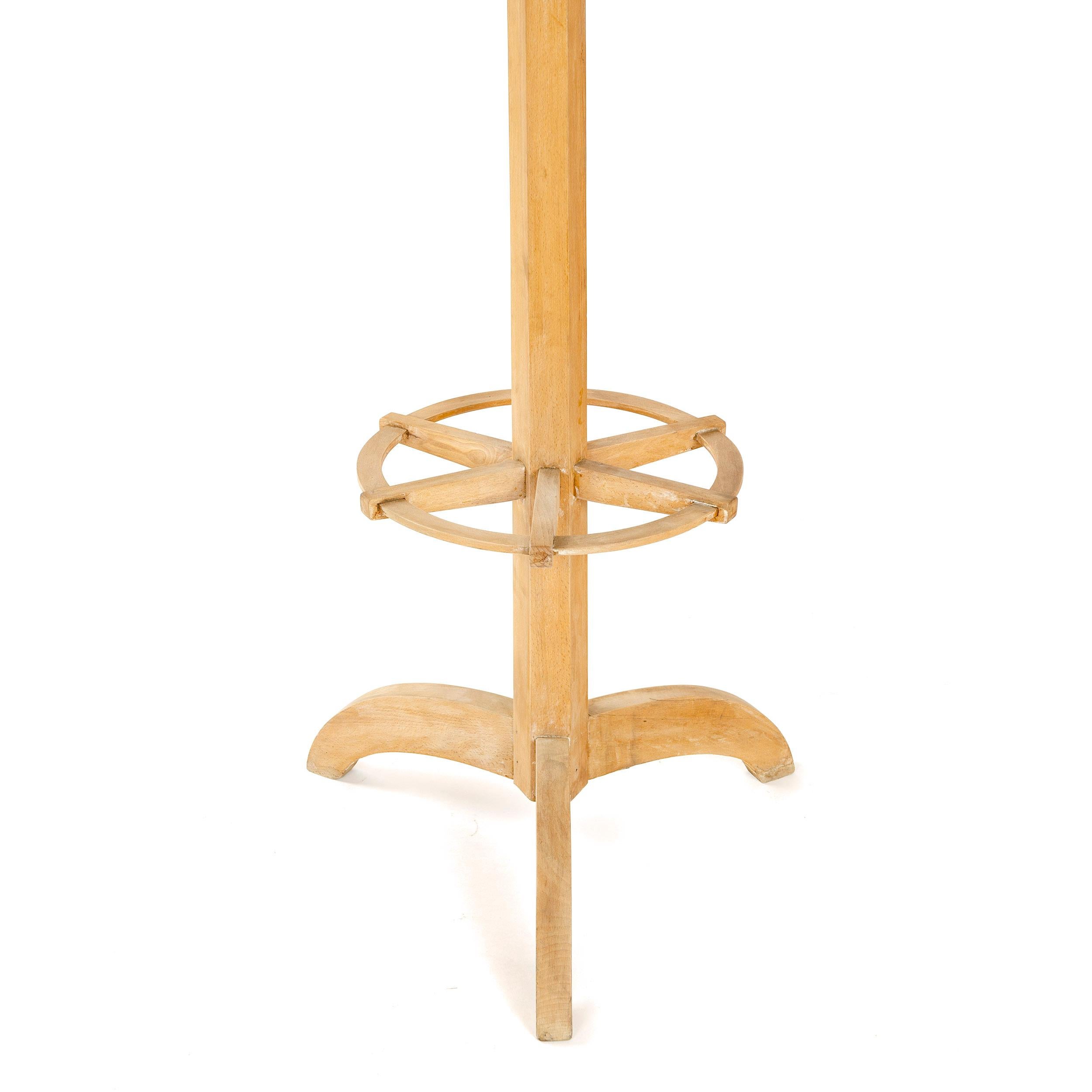 A simple Art Deco coat tree made from solid bleached mahogany with a rotating top.