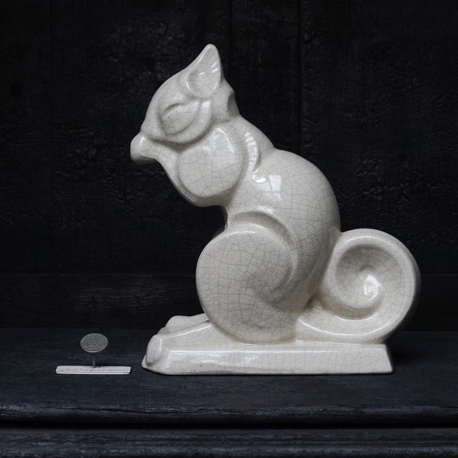 The clean geometric design of this lovely animal makes it very special. Look at the lines of his curled up tail and the way he holds and eats a little nut. I obviously couldn't resist buying it. 
Beautifully crackled glaze and hallmarked on the