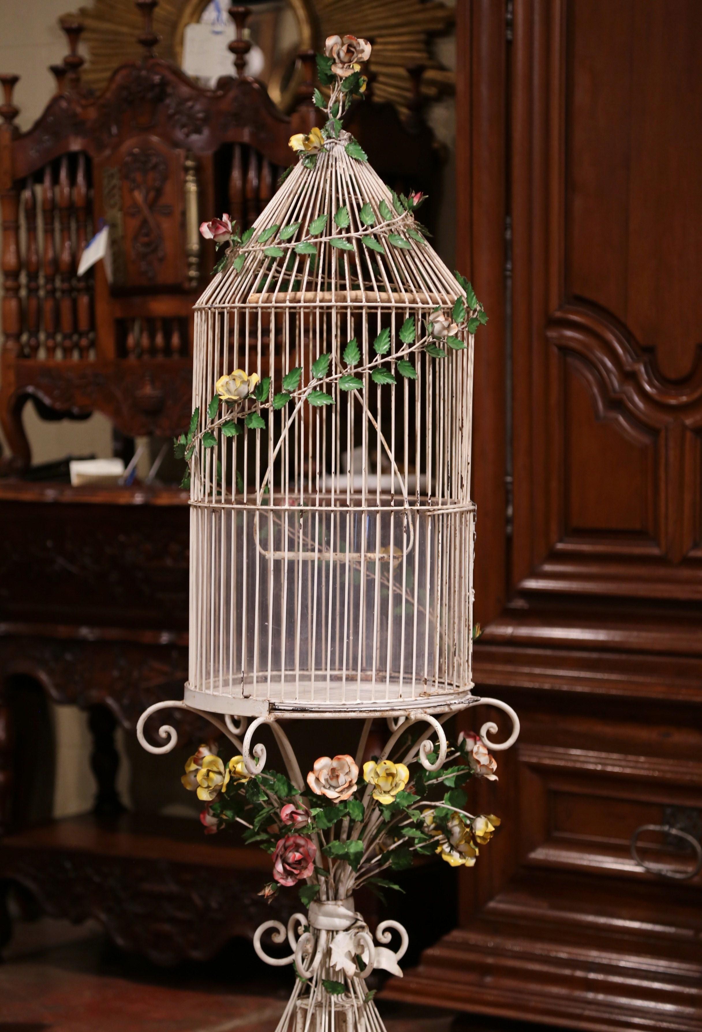 Add color and whimsical charm to your kitchen or breakfast room with this colorful, antique bird cage. Crafted in France, circa 1920 and made of metal, the impressive free standing cage stands on five scrolled legs and is decorated at the shoulder