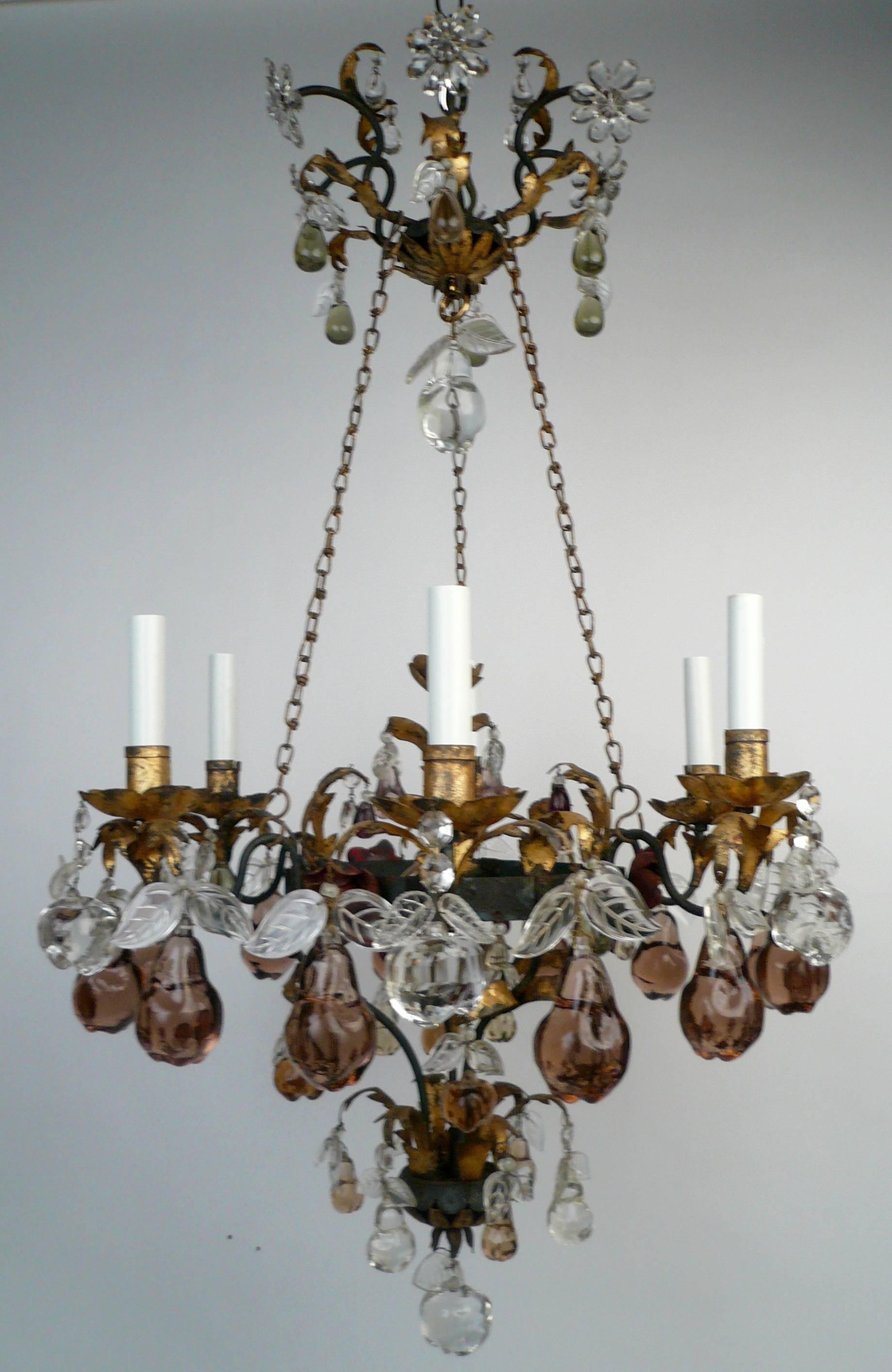 This handmade six-light wrought iron chandelier features gilt highlights and is hung with clear and colored glass fruit form pendants.