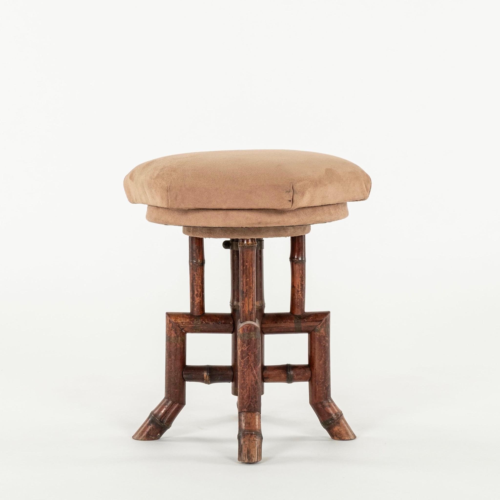 Early 20th Century French bamboo swivel stool newly upholstered in a saddle colored suede.