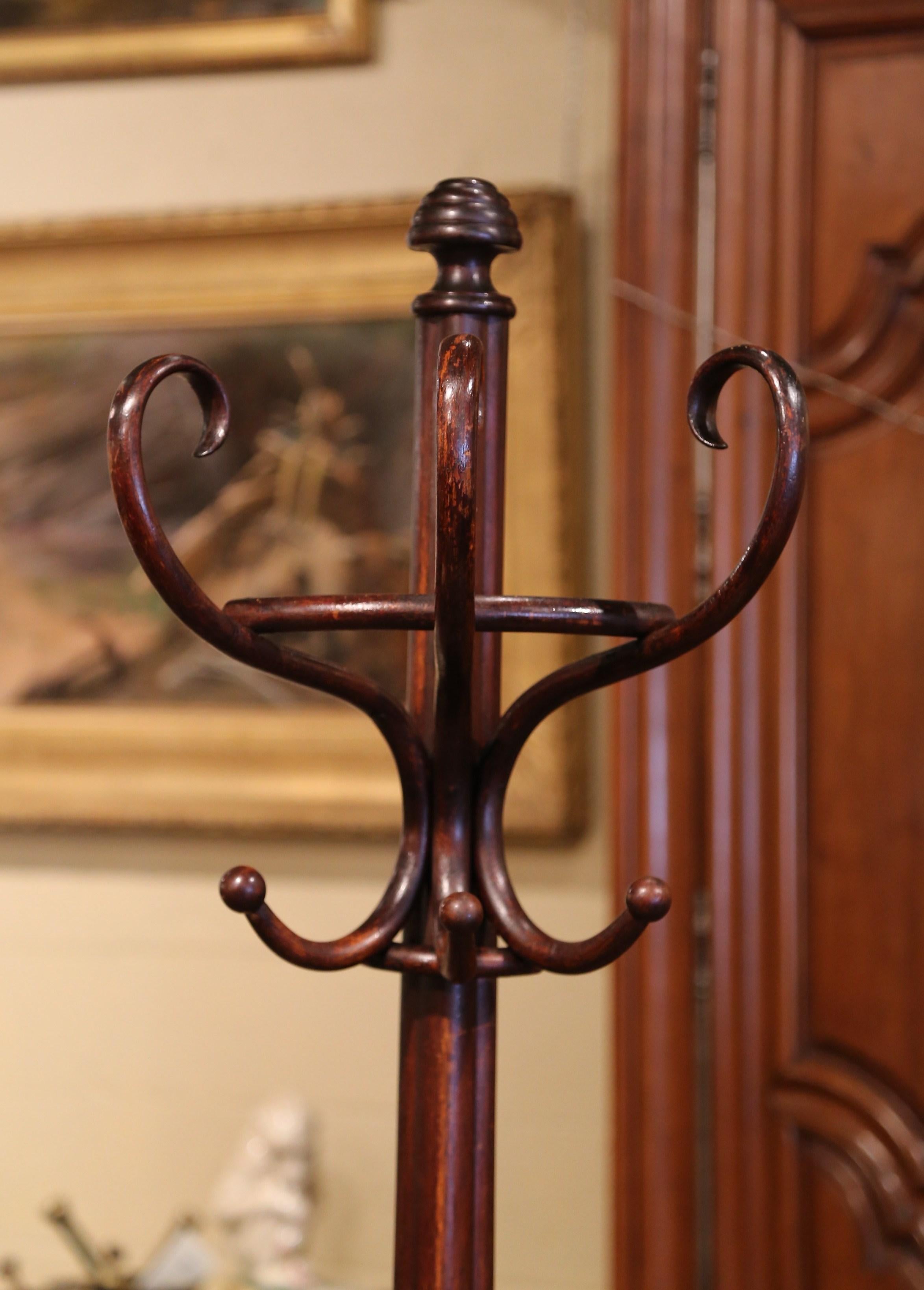 Bring a retro, yet practical touch to any entry or dressing area with this elegant, carved coat stand. The free standing bentwood hall tree was crafted in France, circa 1930, after the German-Austrian cabinet maker, Michael Thonet (1796-1871). The