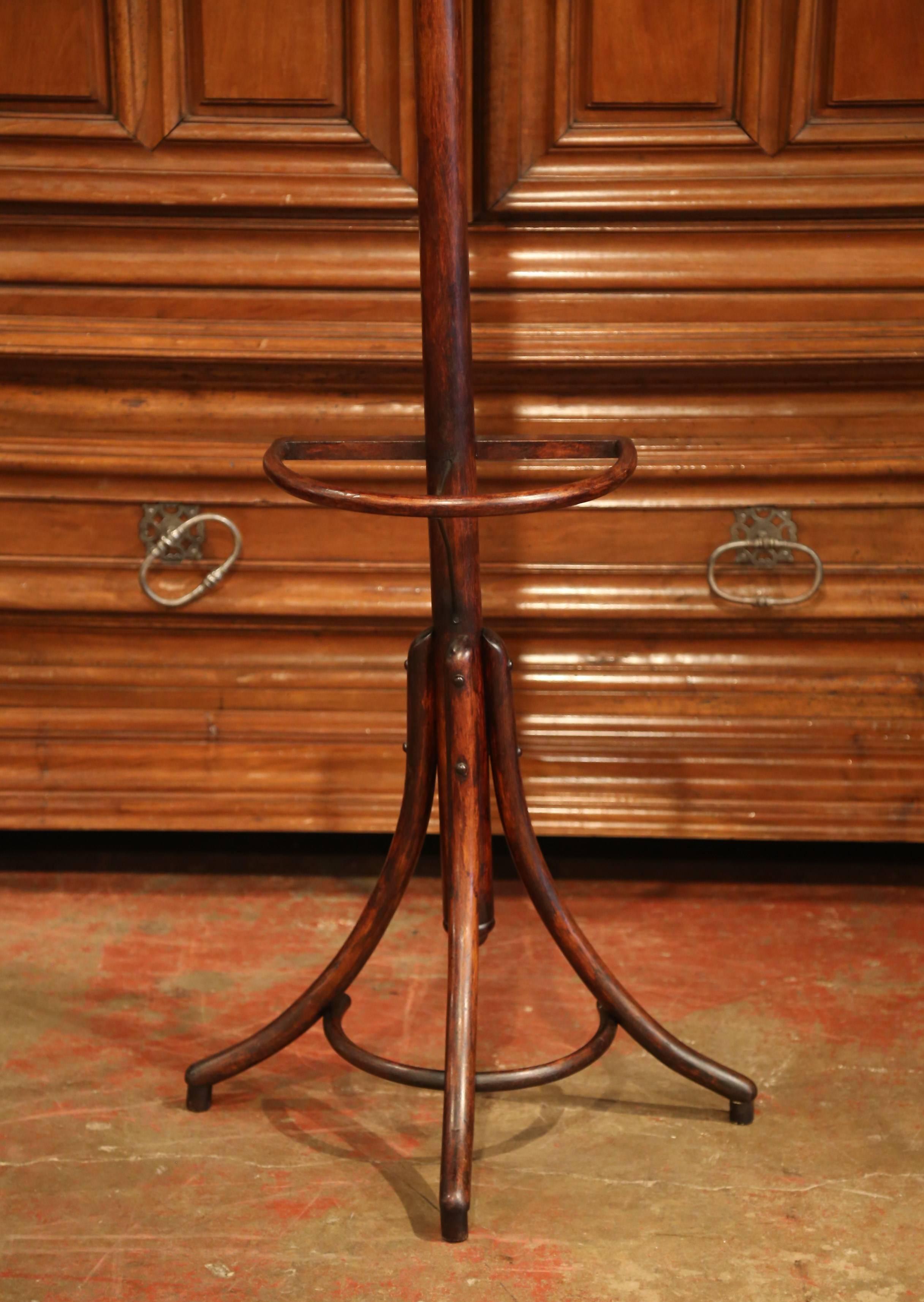 Bring a retro, yet practical touch to any entry or dressing area with this elegant, carved coat and hat stand. The bentwood hall tree was crafted in Paris, France, circa 1930, after the German-Austrian cabinet maker, Michael Thonet (1796-1871). The
