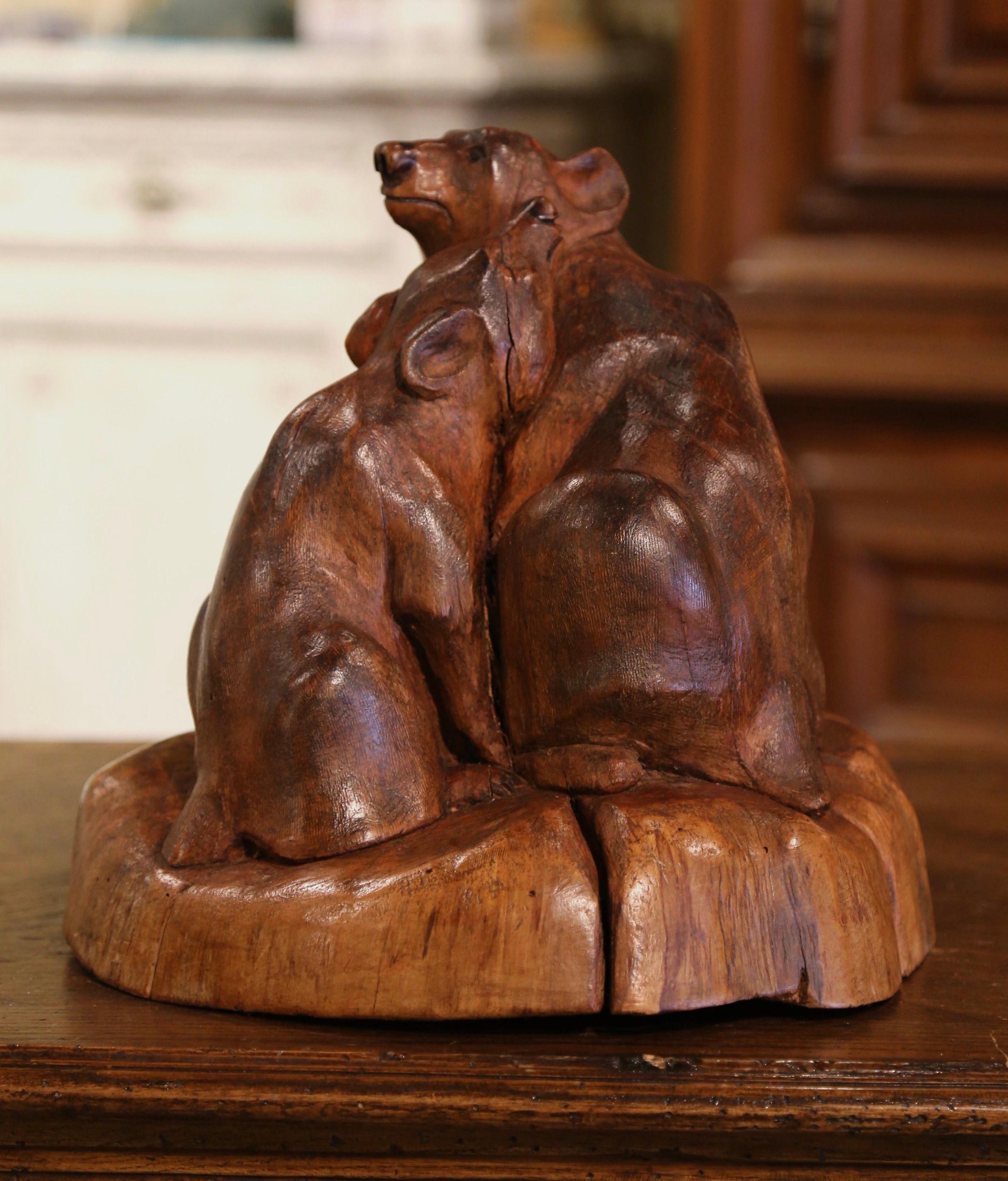 Decorate a ranch or hunt cabin with this beautifully executed, antique bear sculpture composition. Hand carved in France circa 1920 from one piece of fruit wood, the whimsical composition depicts two bears, one standing, one sitting and hugging each