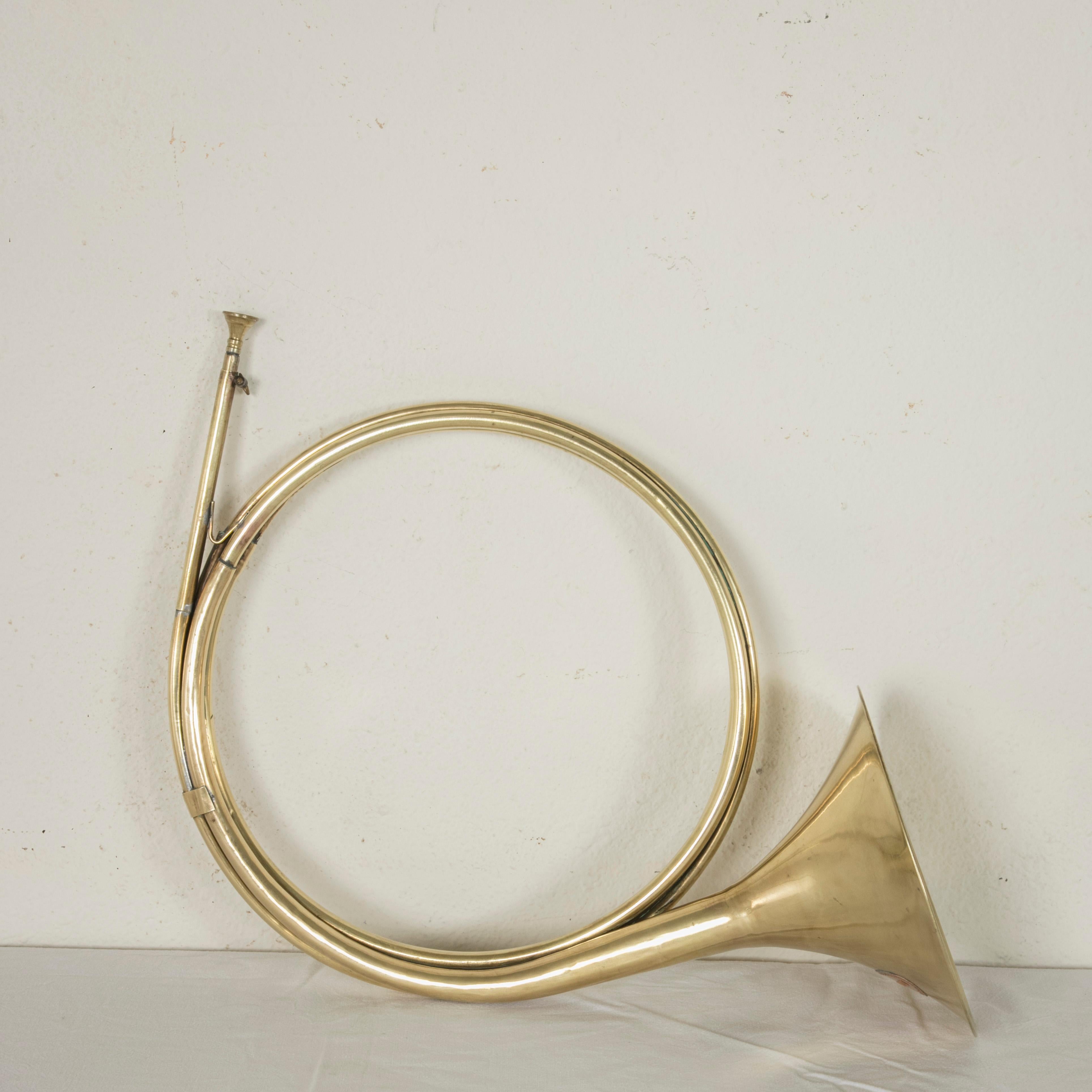 This early 20th century brass horn or coronet was originally used for hunting on the grounds of the Chateau de Chantilly, north of Paris. A copper plaque with a border of beading is marked Chantilly, circa 1910.  The circular part of the horn is 16