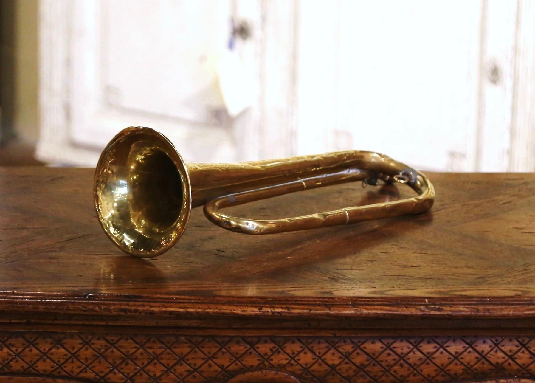 Created in France circa 1920, and built of brass with a silver metal mouthpiece, the horn features a wide end with the following stamp engraving: 