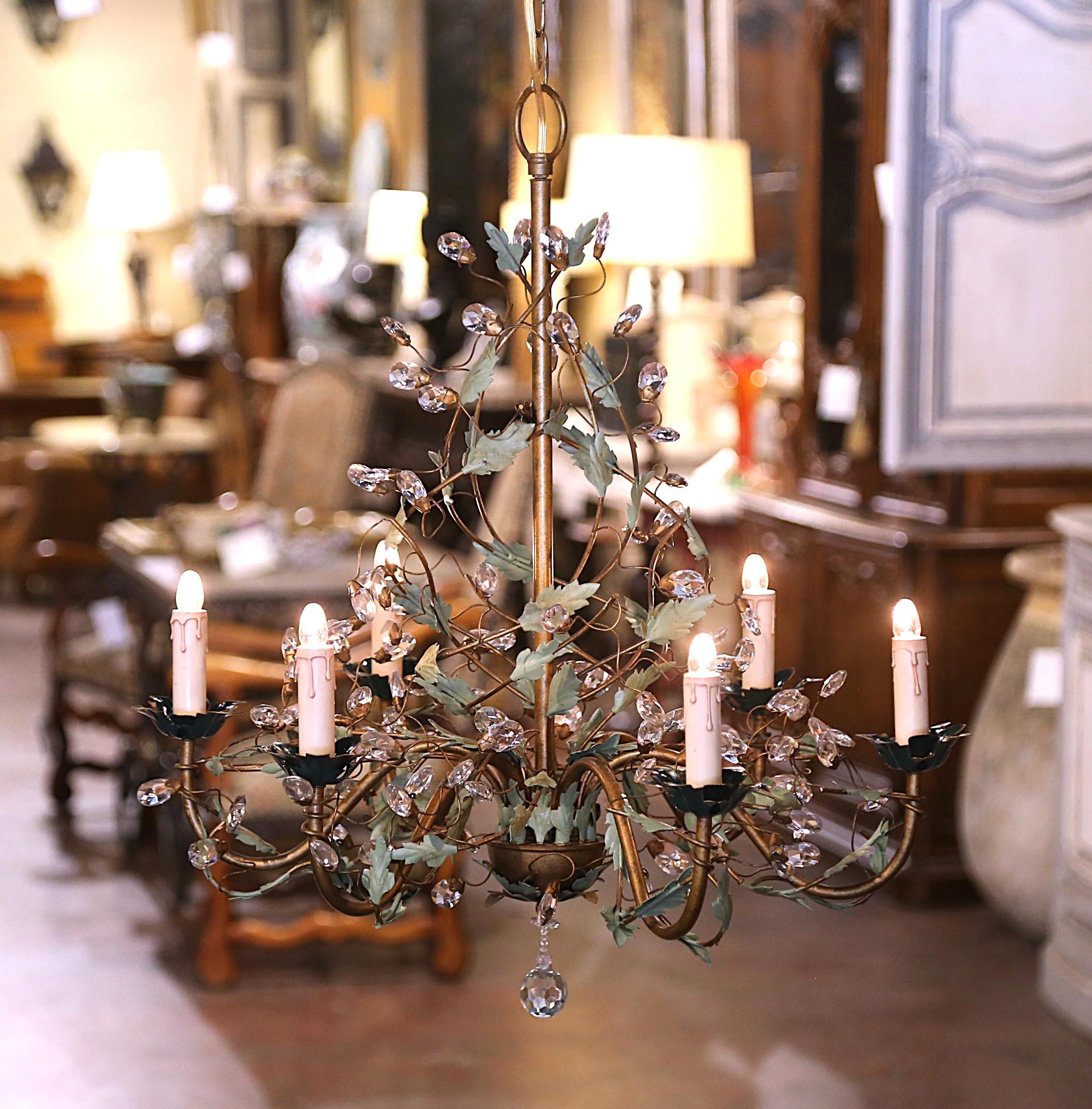 Decorate an entryway, powder room or bedroom with this elegant antique light fixture. Crafted in France circa 1920, and round in shape, the whimsical chandelier with a brass central frame is decorated with crystal drops made to mimic flower buds,