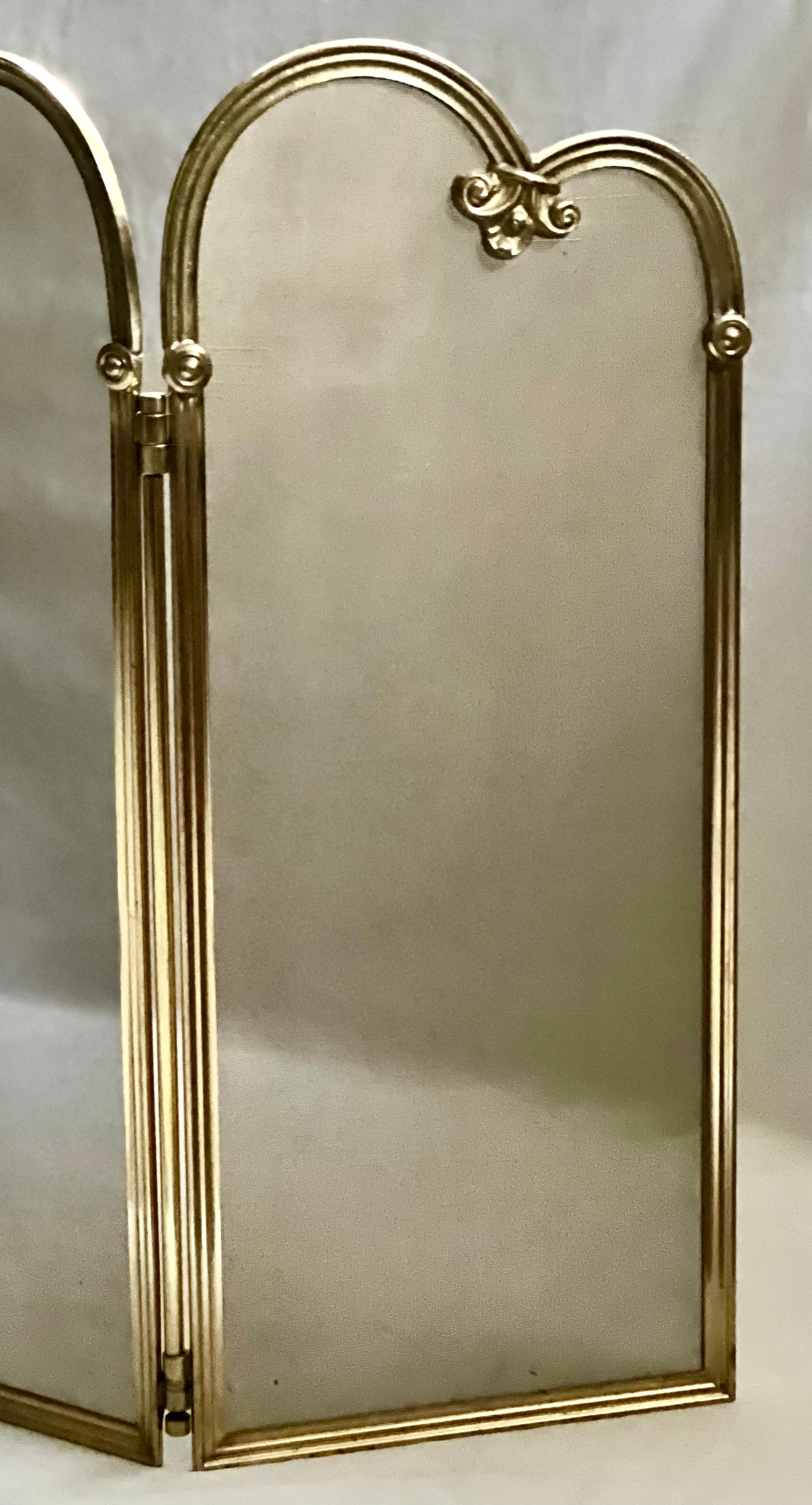 Elegant solid brass French Rococo three-panel fireplace screen. 

The screen features lovely scroll detail and sturdy, high quality hinges secured by a full length brass bar. The brass mesh is welded to seamlessly adhere to the frame. Adjustable