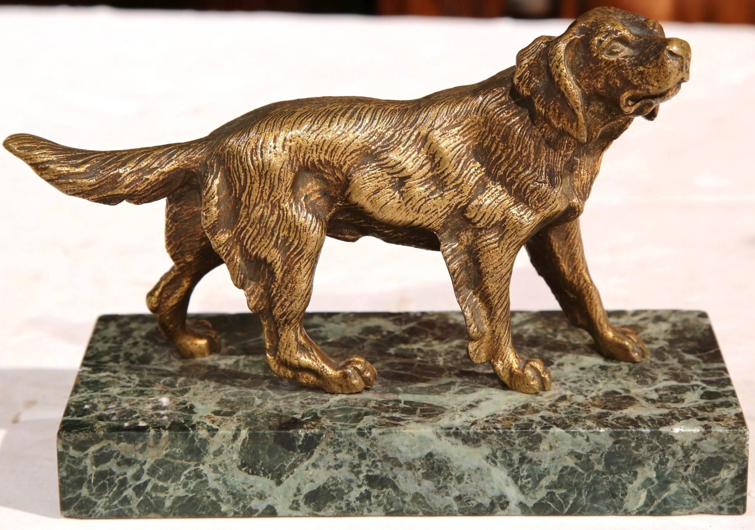 This beautiful, small bronze dog sculpture on a marble base was crafted in France, circa 1920. The hunting setter dog stands on a green rectangular base. From the position of the dog to the details through its face and fur, the sculpture is artfully
