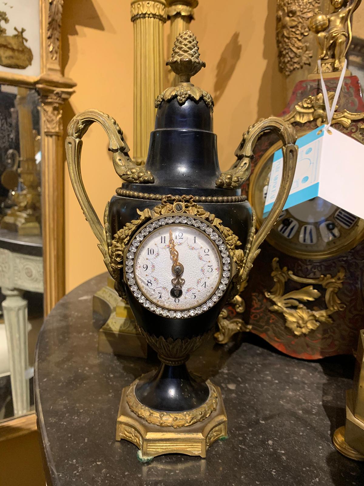 Early 20th century French bronze and tole diamonte urn form clock with wreath detail, signed JP
circa 1900.