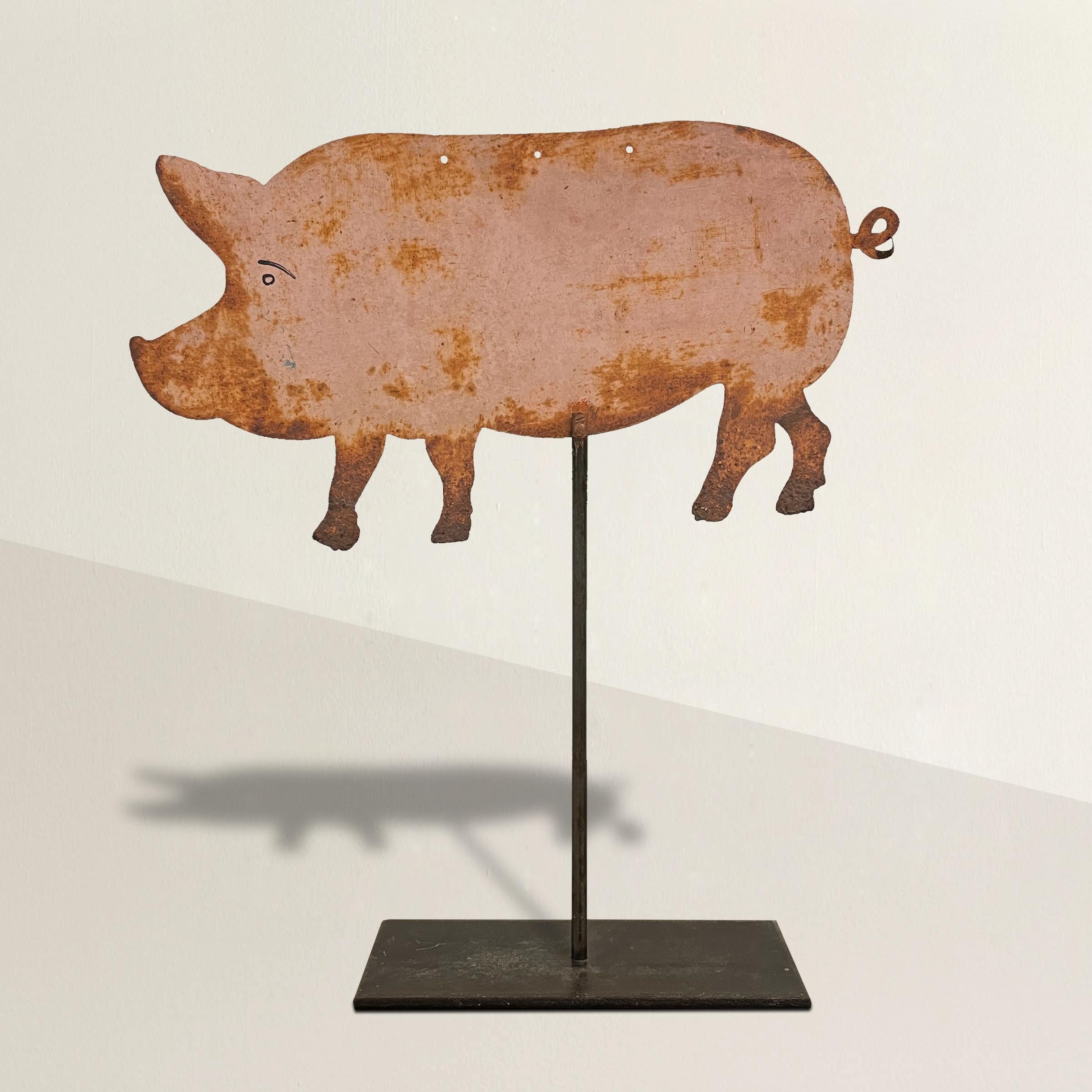 A playful early 20th century French painted steel butcher's shop sign in the shape of a pig, and mounted on a custom steel table-top mount. The sign originally hung from the three holes running along the back of the pig.