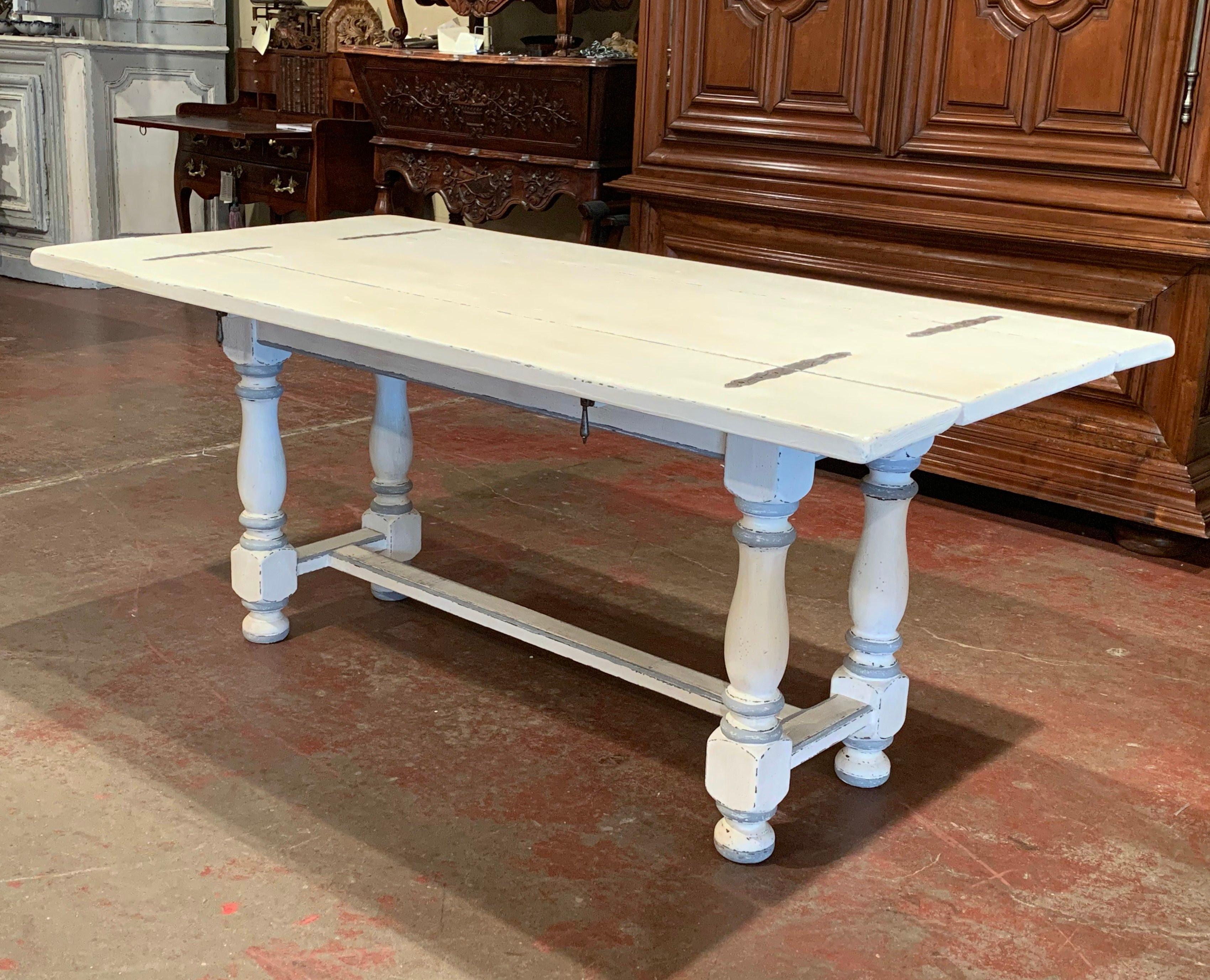 Place this elegant console table against a wall or behind a sofa for extra display space. Crafted in Southern France circa 1920, the traditional, painted table features four carved turned legs embellished with a bottom stretcher. The top has two