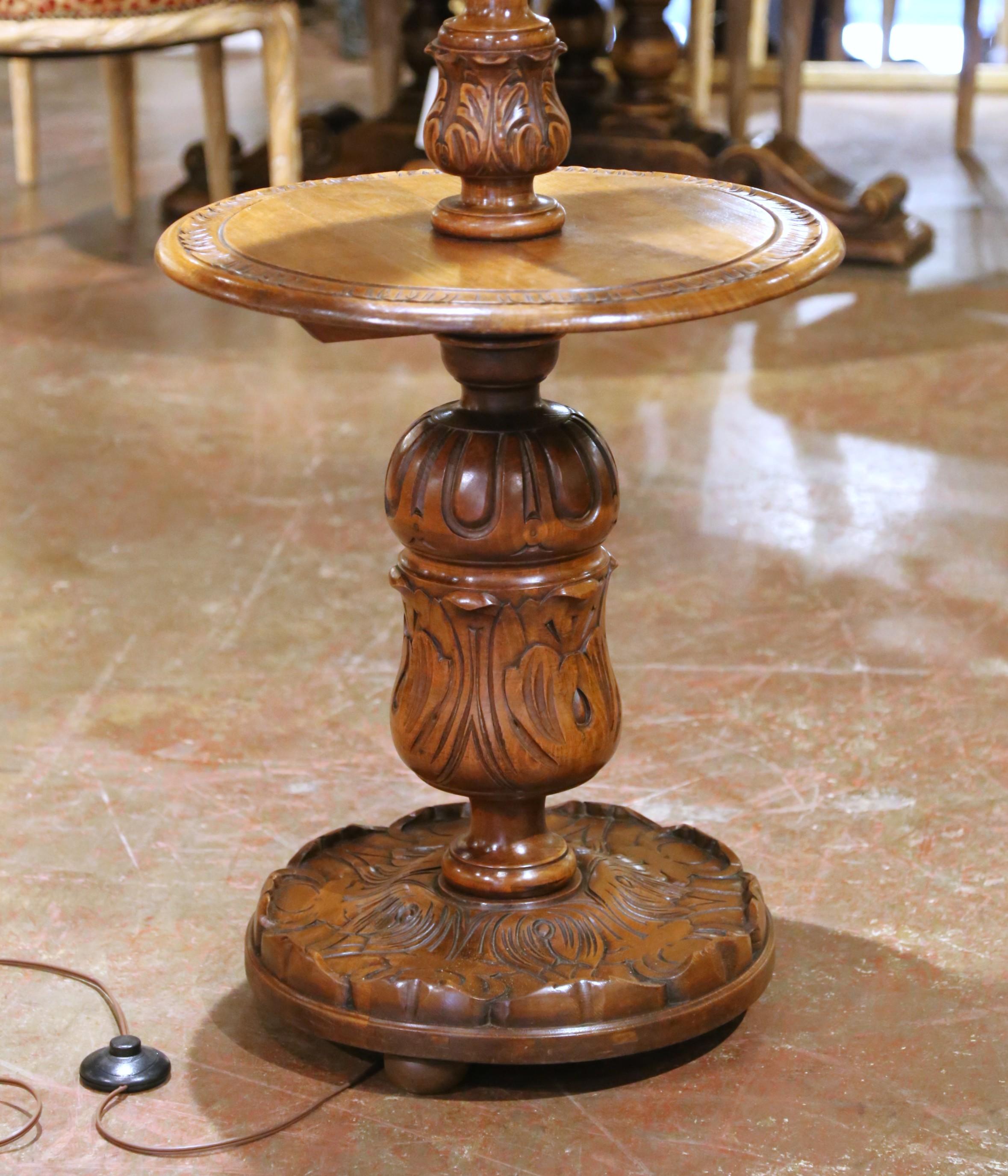 Elevate your interior with this elegant French floor lamp crafted in solid beech and oak wood, circa 1920. The tall, sculptural silhouette features a classic barley twist column rising from a deeply carved circular base, evoking the bold lines and