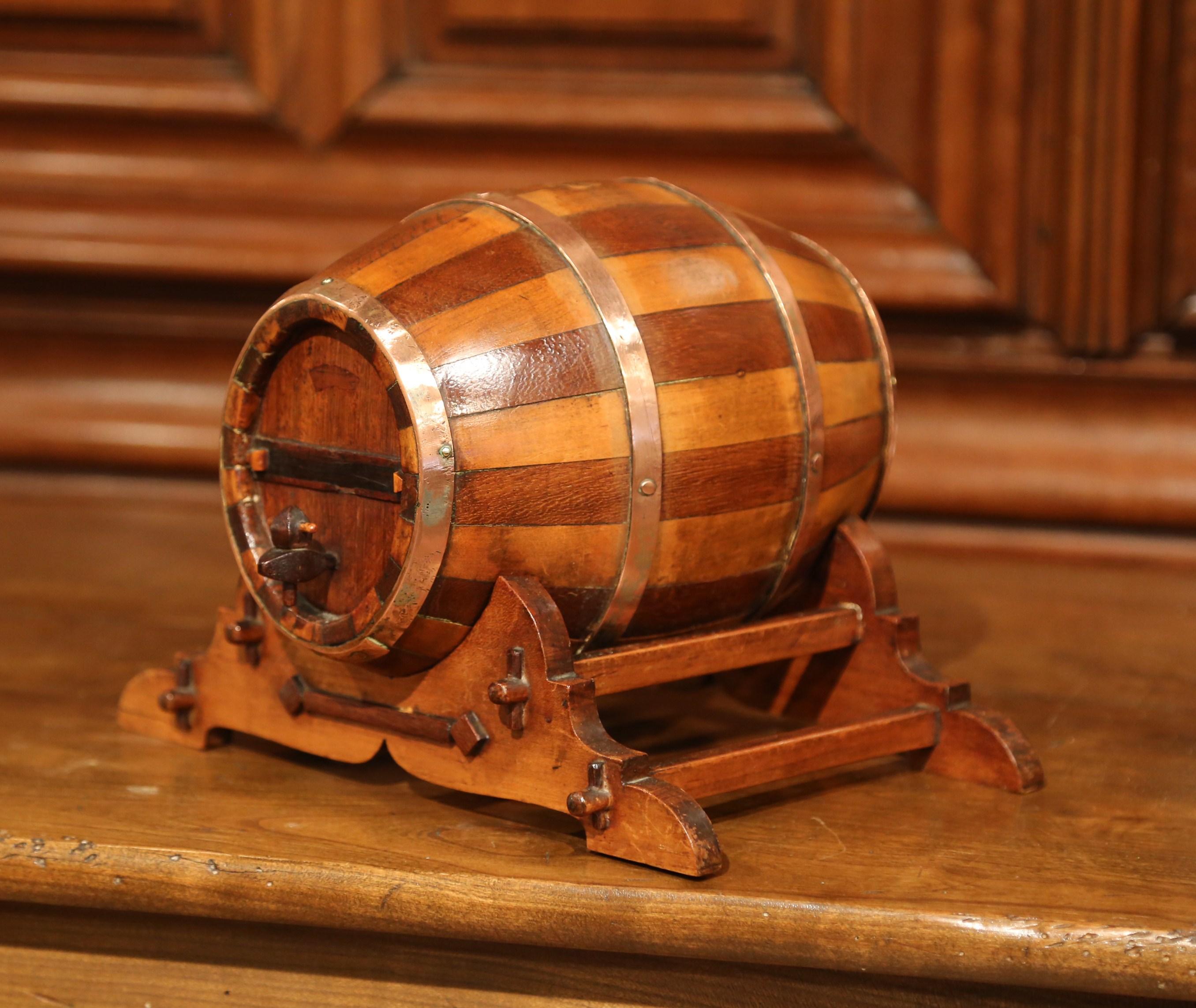 Accessorize your wet bar with this antique, decorative fruit wood and oak barrel sculpture. Crafted in Cognac circa 1930, the barrel is secured on stand and flaunts a beautiful walnut patina. The oval wood barrel features brass rims and decorative