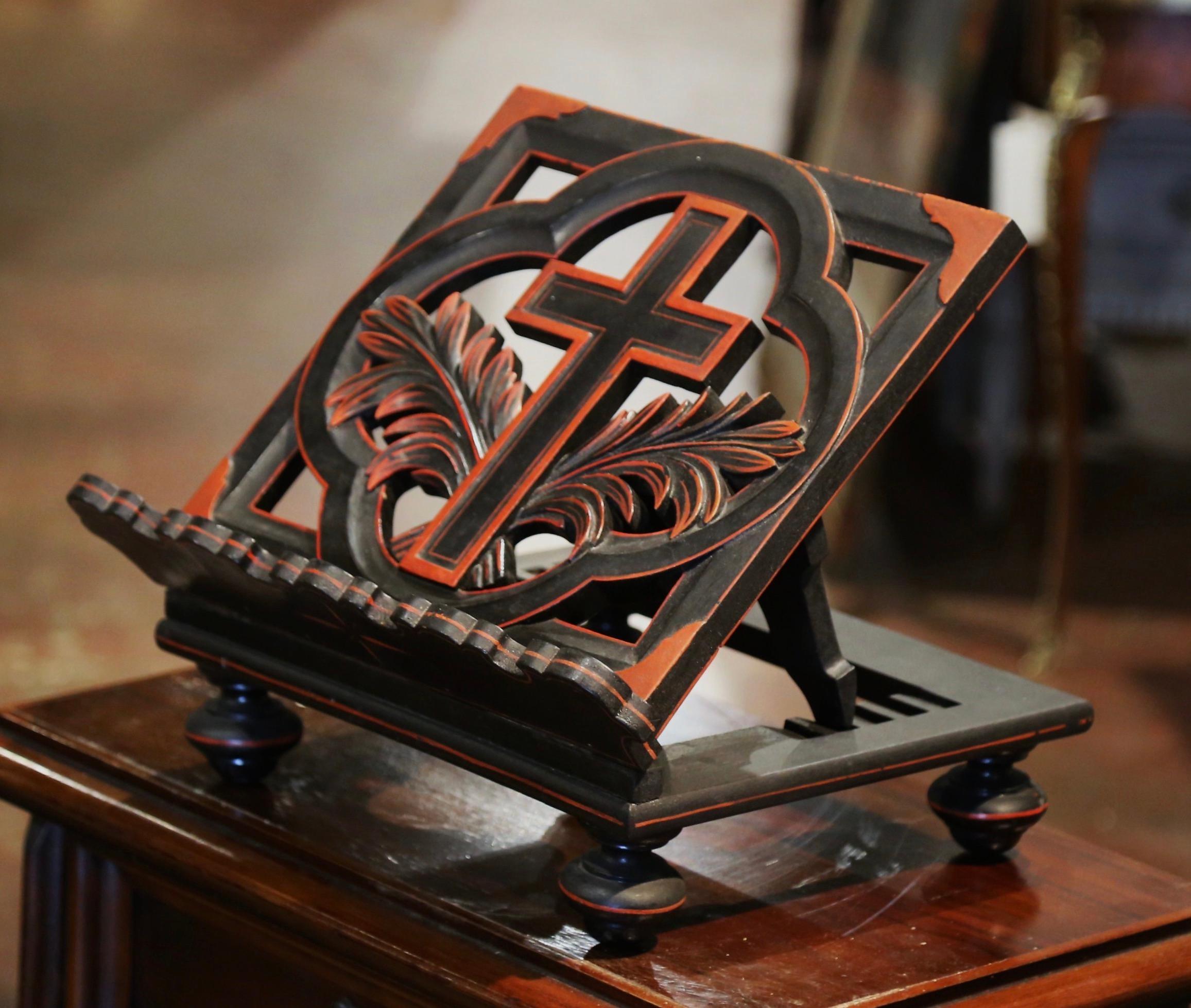Place a Bible on this antique stand for easy reading! Created in France, circa 1920, and built of mahogany, the Classic book holder sits on round feet over a rectangular base. The stand features a center medallion with a large carved cross flanked