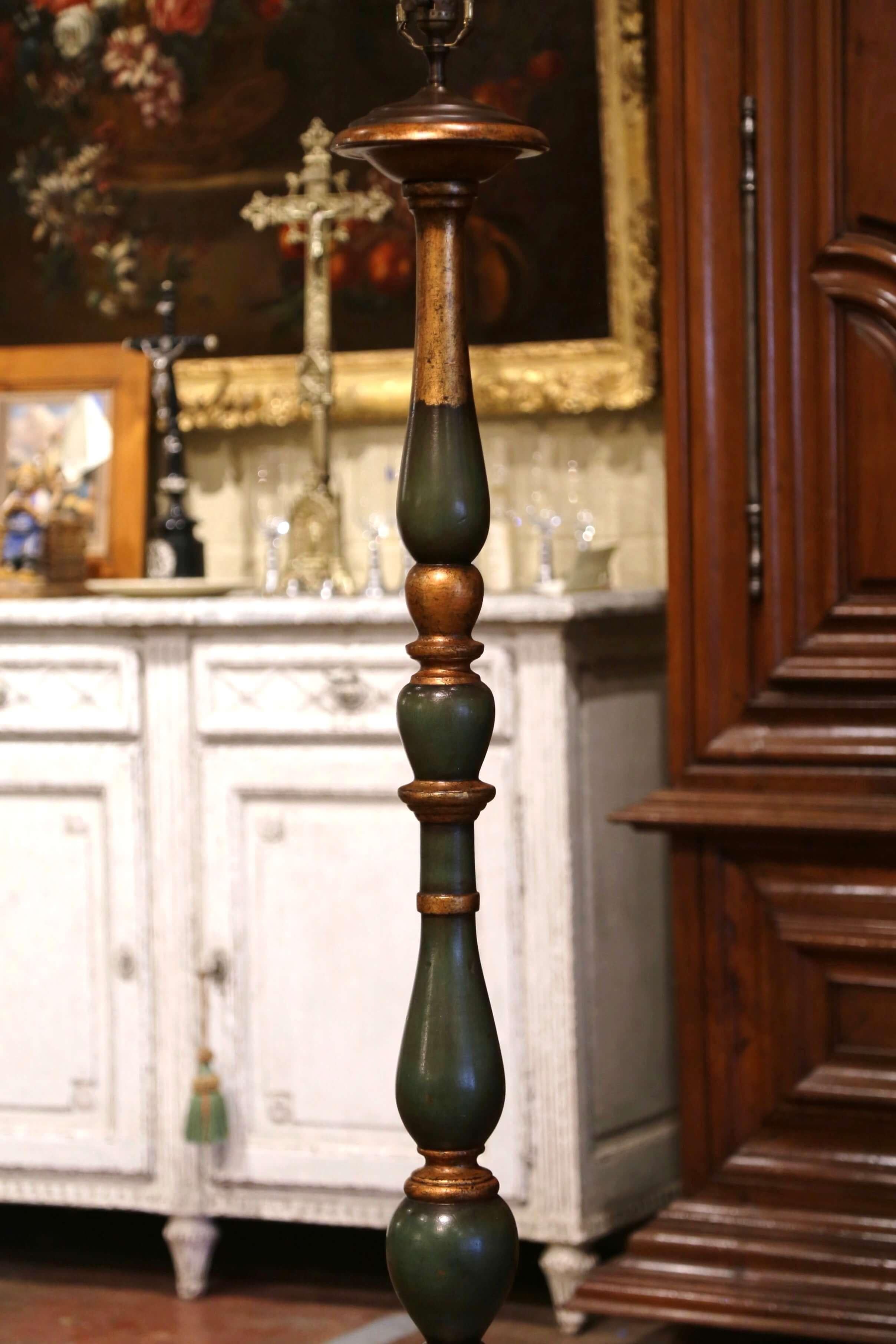 This elegant antique floor lamp was crafted in France, circa 1920. The lamp stands on a round stem over a long carved and turned stem; the fixture is dressed with a single center light. The floor lamp is in excellent condition commensurate with age