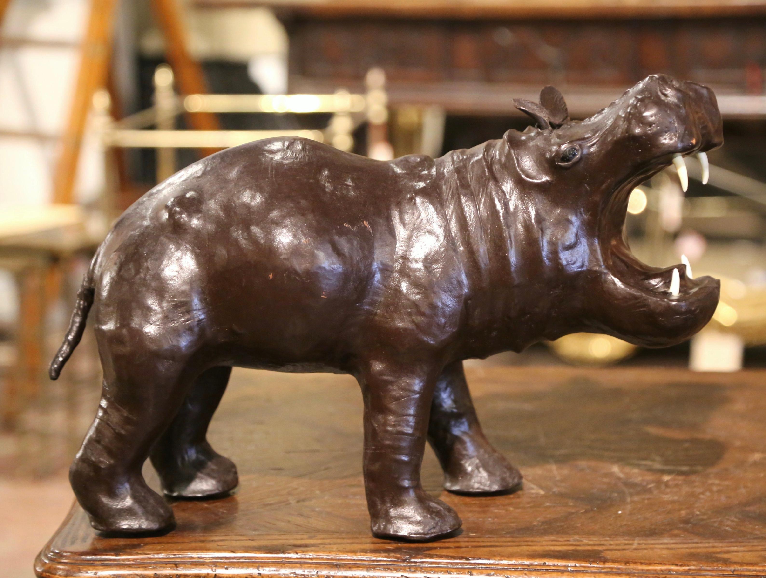 This beautiful, antique hippopotamus sculpture was crafted in France, circa 1920. The detailed leather figure standing on his four legs is in excellent condition and adorns a rich old patinated finish. the hippo's mouth is open as if it was roaring