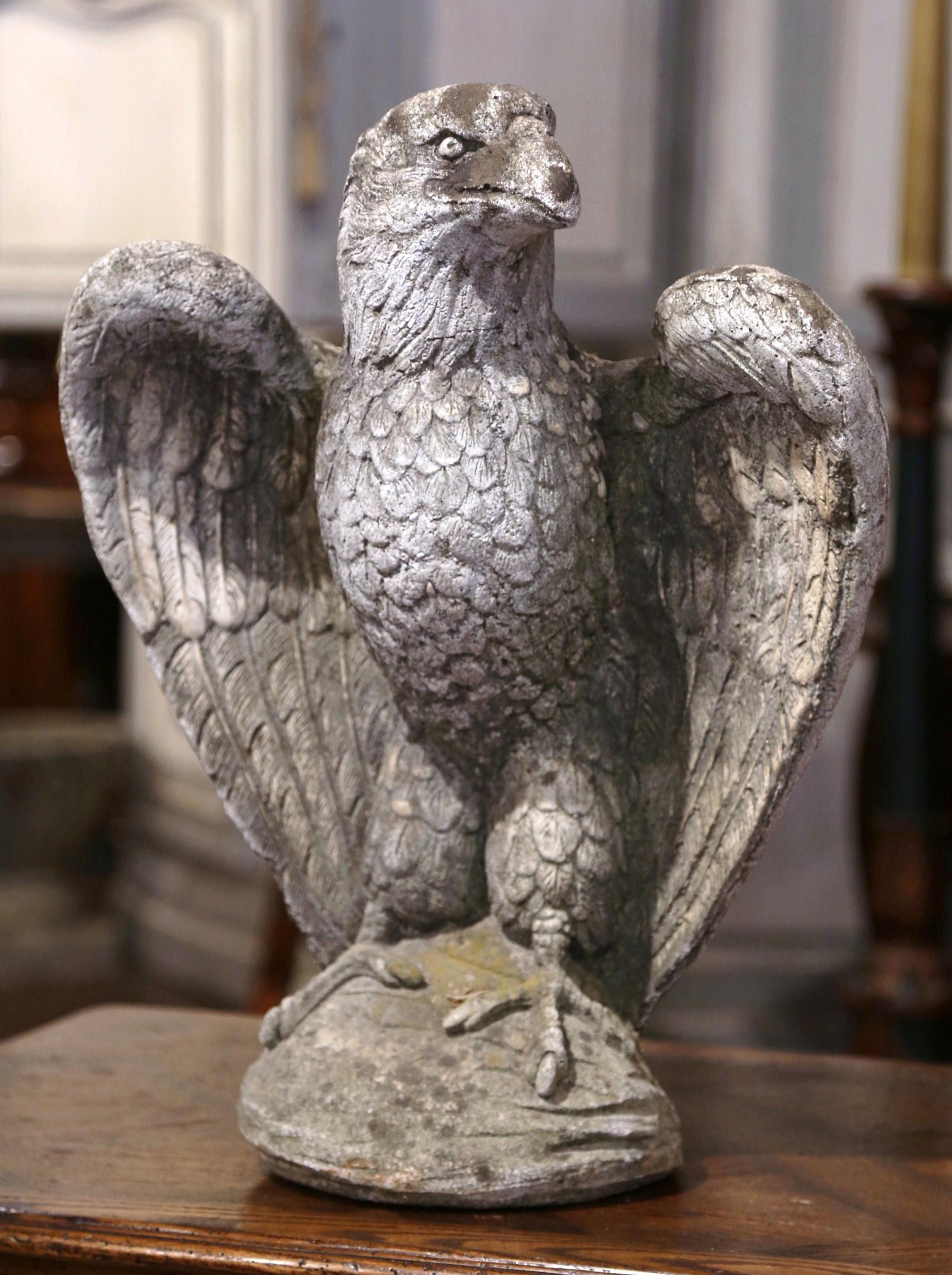 Decorate a garden or a patio with this large antique stone eagle sculpture. Crafted in Southern France circa 1920, the tall piece features an eagle standing on a rock, with its wings fully opened. The bird figure is in excellent condition with a
