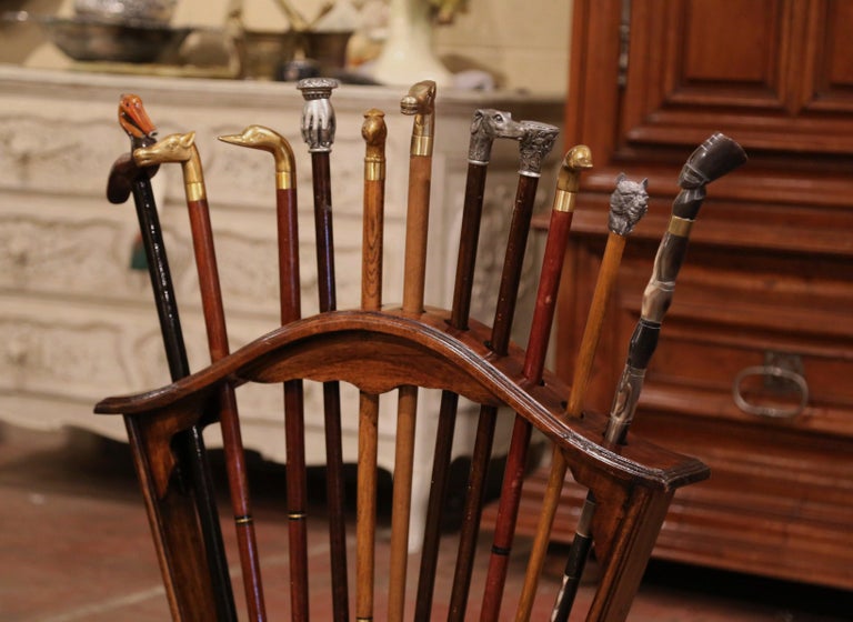 Early 20th Century French Carved Walnut Cane Stand with Eleven Antique