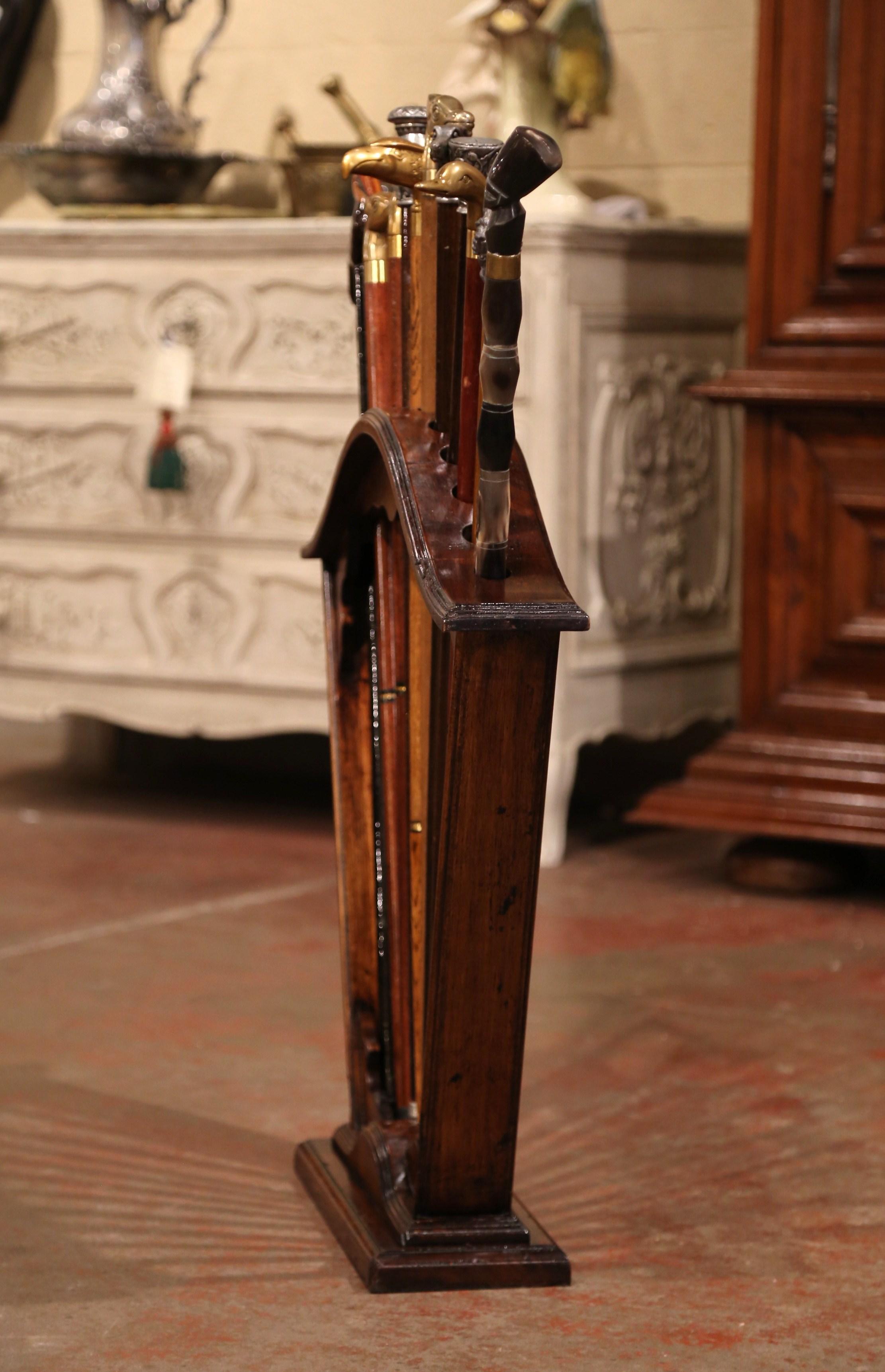 Early 20th Century French Carved Walnut Cane Stand with Eleven Antique