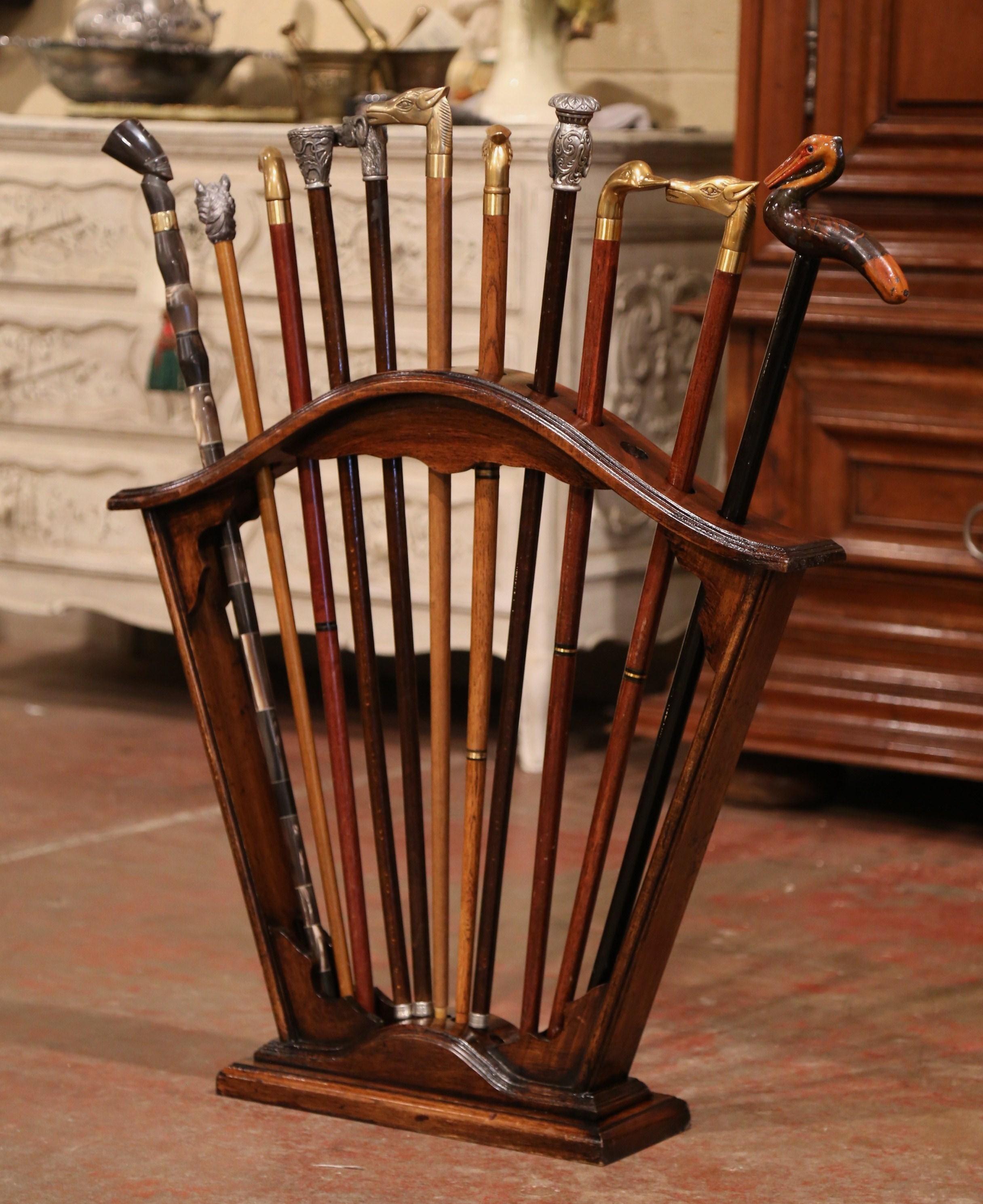 Early 20th Century French Carved Walnut Cane Stand with Eleven Antique