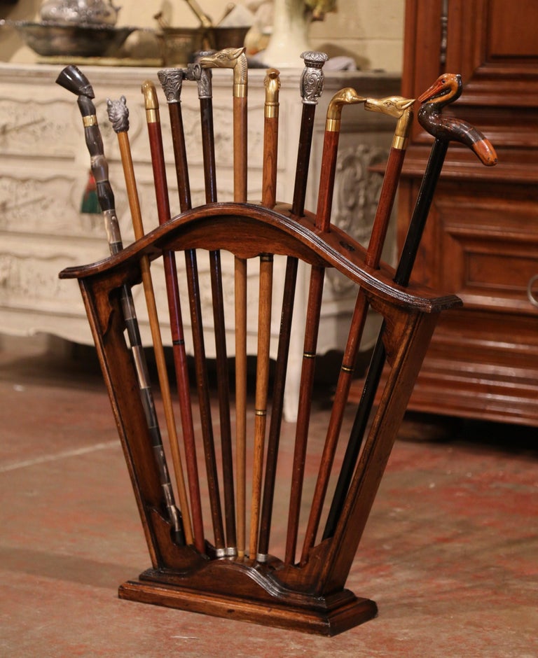 Early 20th Century French Carved Walnut Cane Stand with Eleven Antique