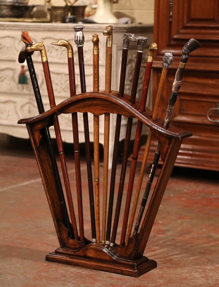 Early 20th Century French Carved Walnut Cane Stand with Eleven Antique