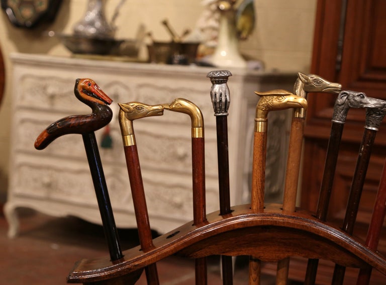 Early 20th Century French Carved Walnut Cane Stand with Eleven Antique