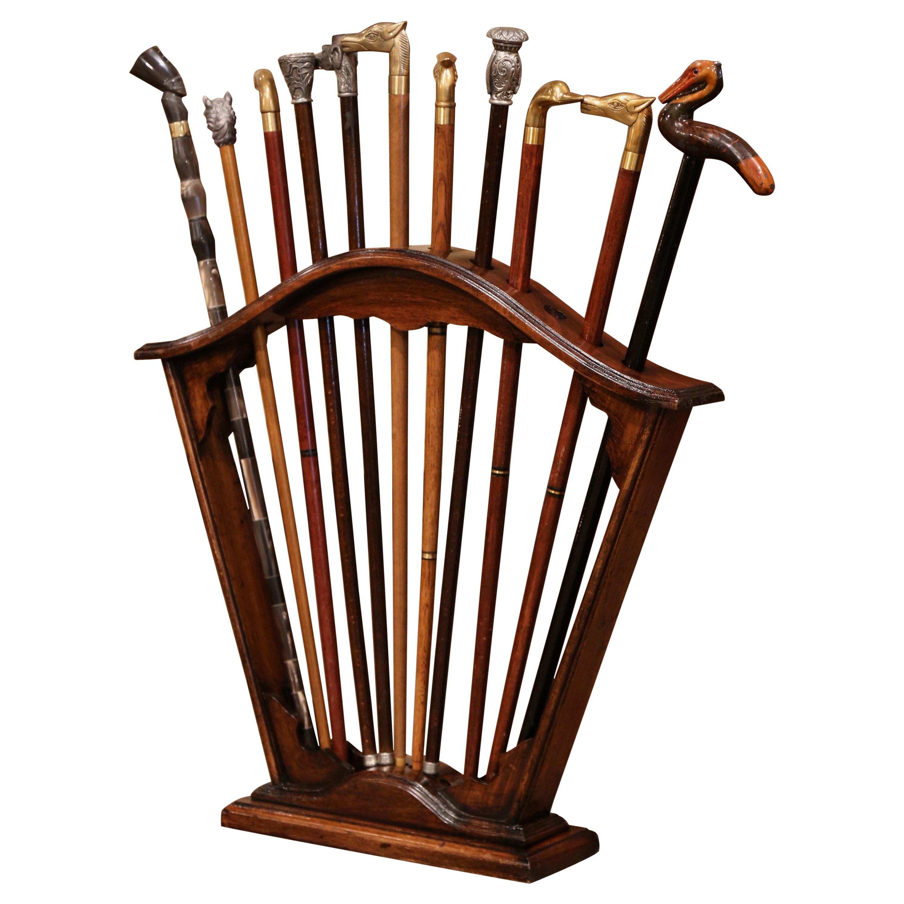 Early 20th Century French Carved Walnut Cane Stand with Eleven Antique