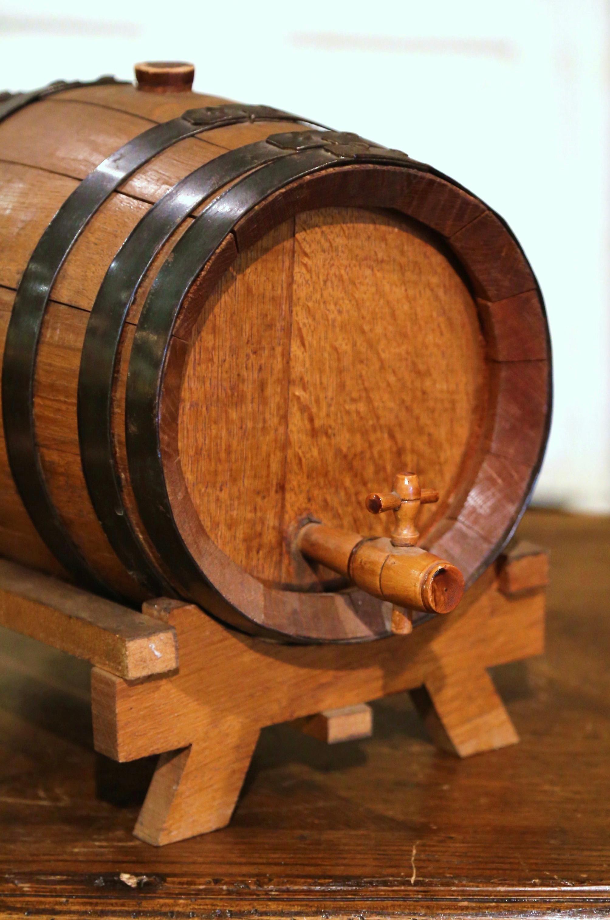 Accessorize your bar with this antique brandy barrel from Cognac. Crafted circa 1920, this oval oak barrel is embellished with six joining brass rims with original flat nailheads. It sits on a separate, removable base and features the original