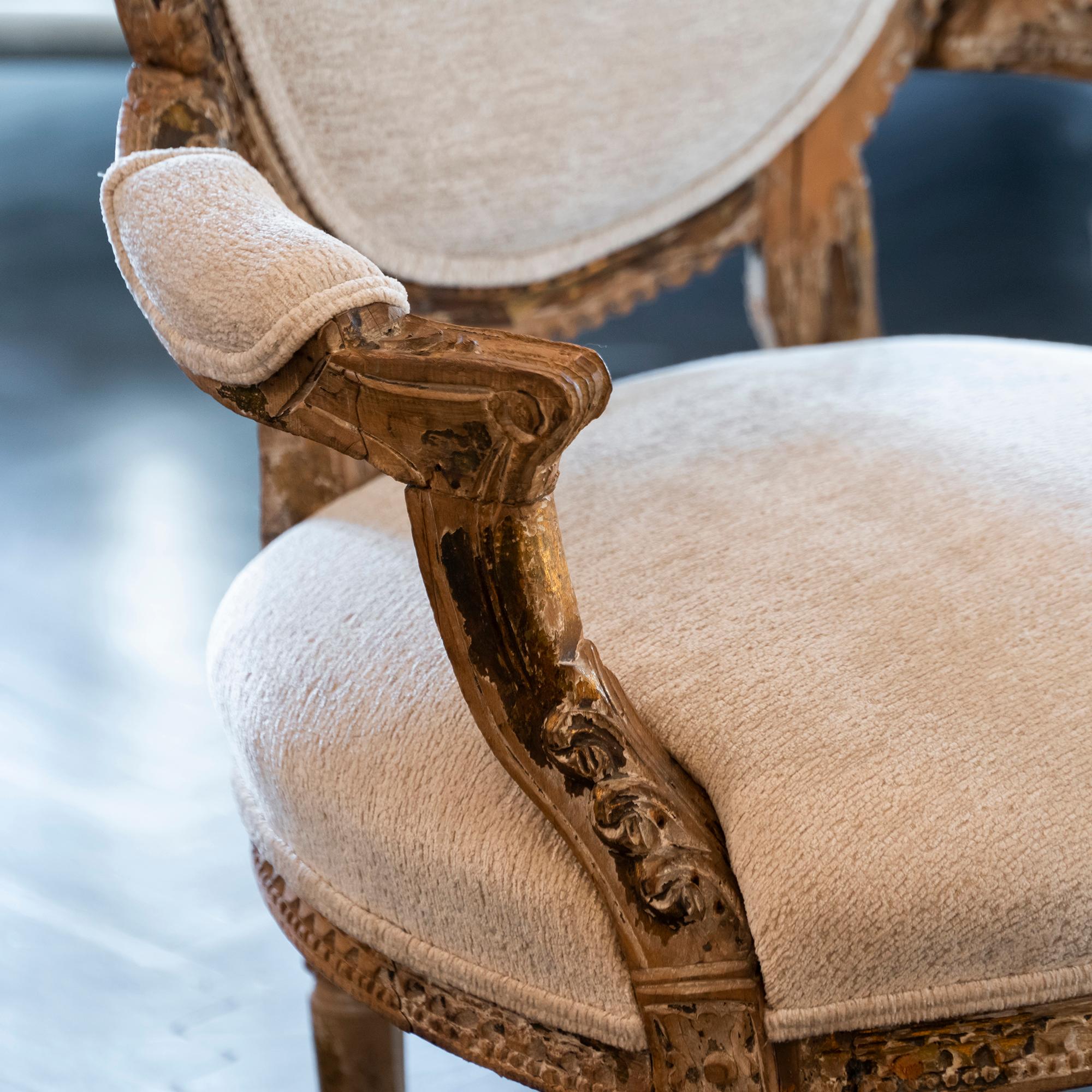 Early 20th century French carved wood armchair in perfect condition and vintage patina, newly reupholstered in ivory velvet.
