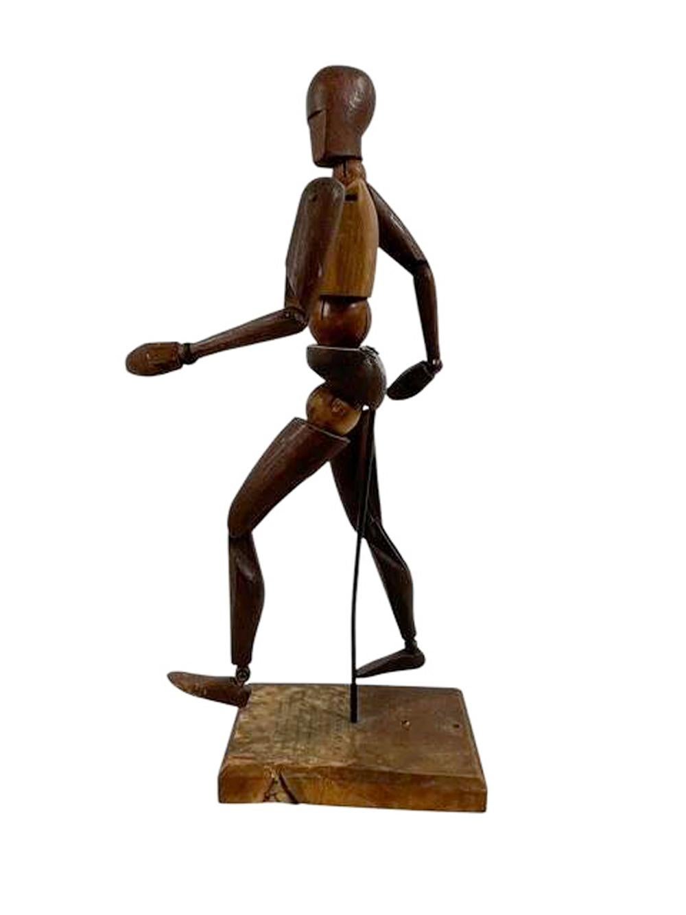Art Deco articulated carved wood artist's mannequin or lay figure on its original display stand and retaining its paper label.