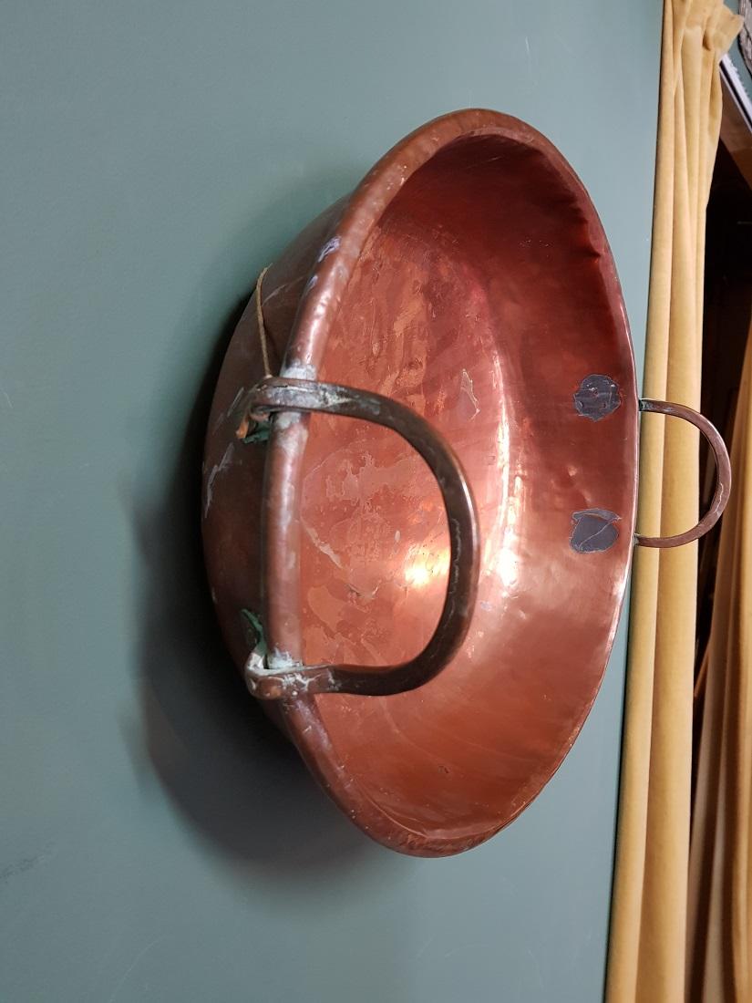 Old French copper jam pan with riveted brass handles in a used condition which resulted in a beautiful patina, it's from circa 1900.

The measurements are,
Diameter 39.5 cm/ 15.5 inch.
Height 10.5 cm/ 4.1 inch.