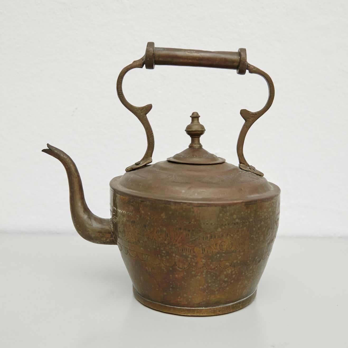 Early 20th century brass teapot.  By unknown manufacturer, France.    In original condition, with minor wear consistent with age and use, preserving a beautiful patina.    Materials:  Brass    Dimensions:  D 14 cm x W 24 cm x H 26.5 cm.