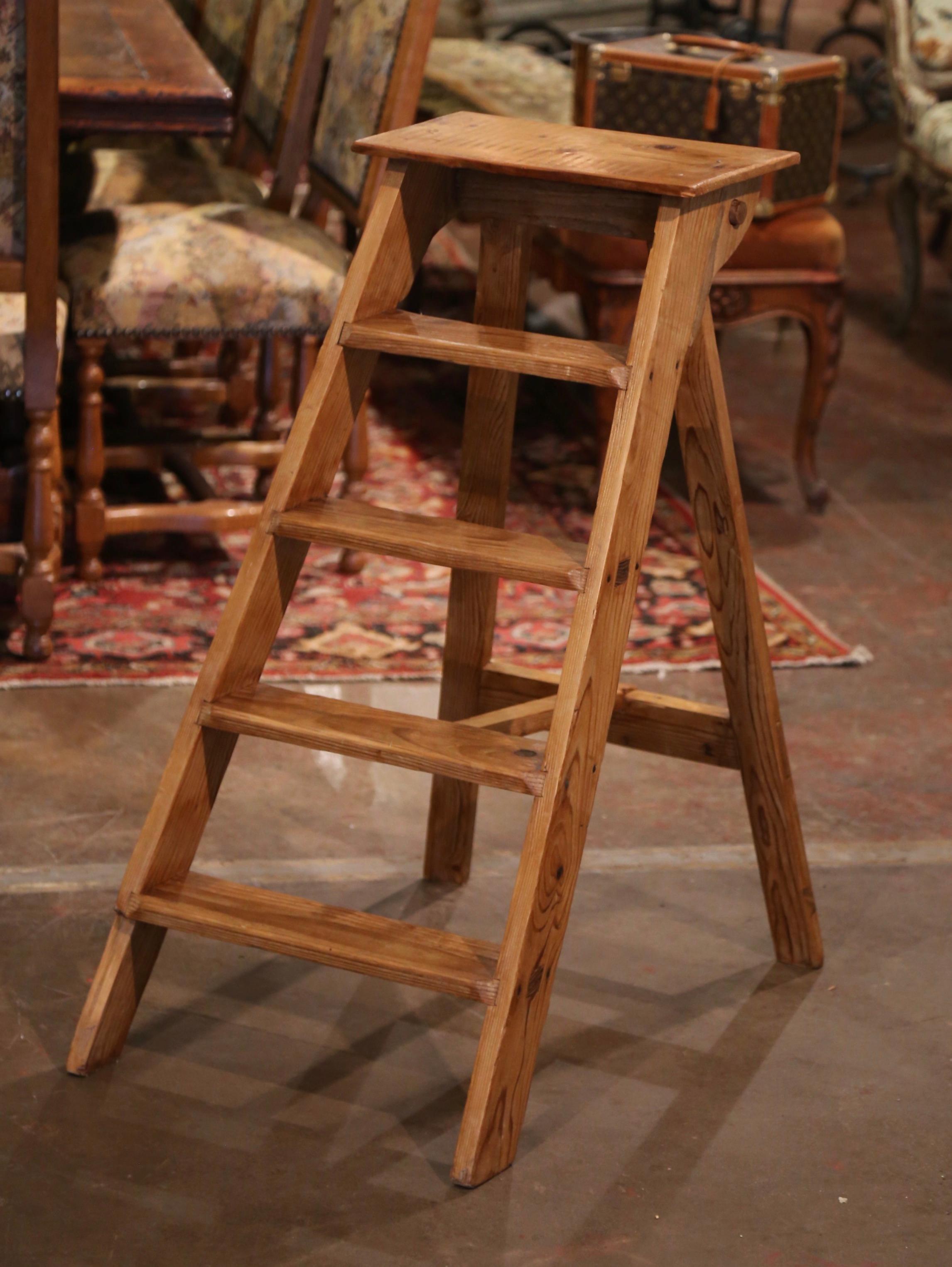 This elegant three foot antique library ladder was created in Normandy France, circa 1920. Made of pine, the sturdy step ladder features five steps including a wider and deeper step at the top. Practical and useful, the rustic ladder can be put away