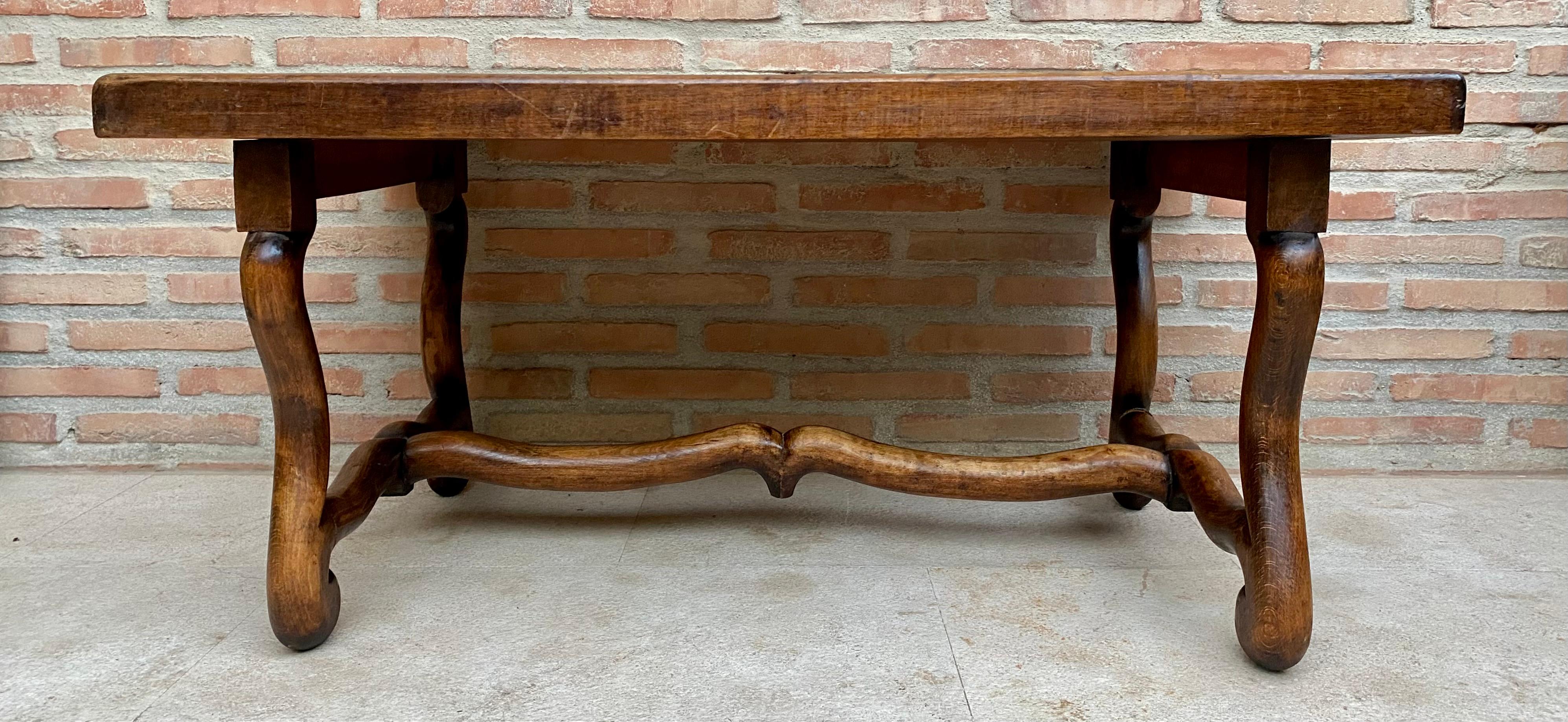 Vintage French style side table, France, 1940s.

This beautiful small table from the Île-de-France region is made of oak, it has a deep color created with a glaze over walnut stain to give the piece an aged look. The elegant legs are joined by a