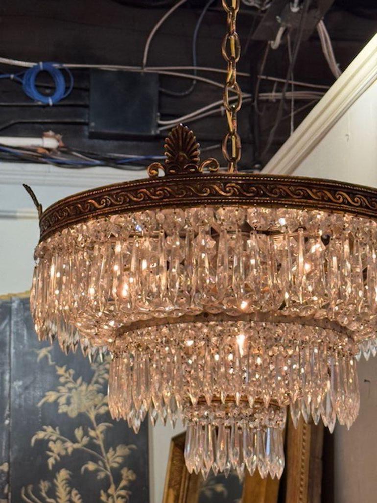 This early 20th century Pair of French Crystal Flush Mount Chandeliers are stunning lighting fixtures that exudes elegance and sophistication. Crafted with intricate crystal details, this flush mount chandeliers showcase the beauty of French