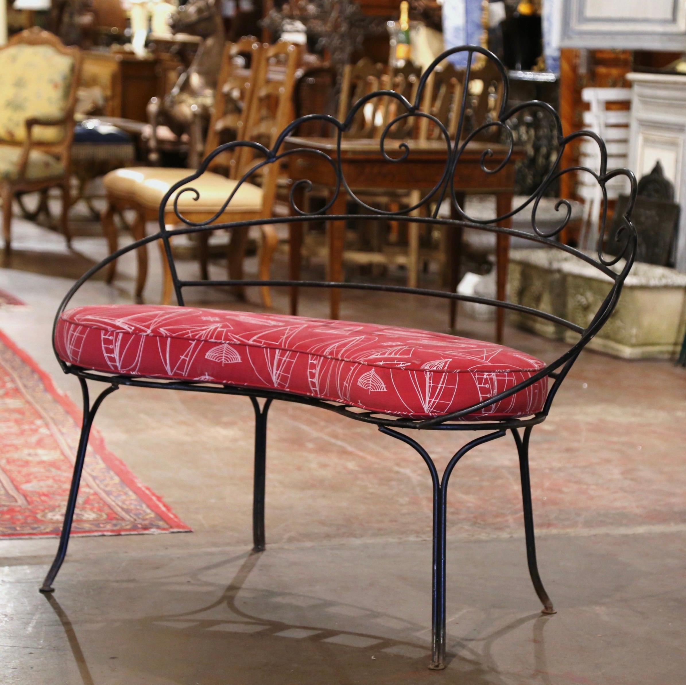 Add extra seating to an outdoor space, porch or patio with this elegant antique iron bench. Crafted in northern France circa 1920, the rounded bench sits on four curved legs. The delicate garden bench has gracious lines and a beautifully shaped back