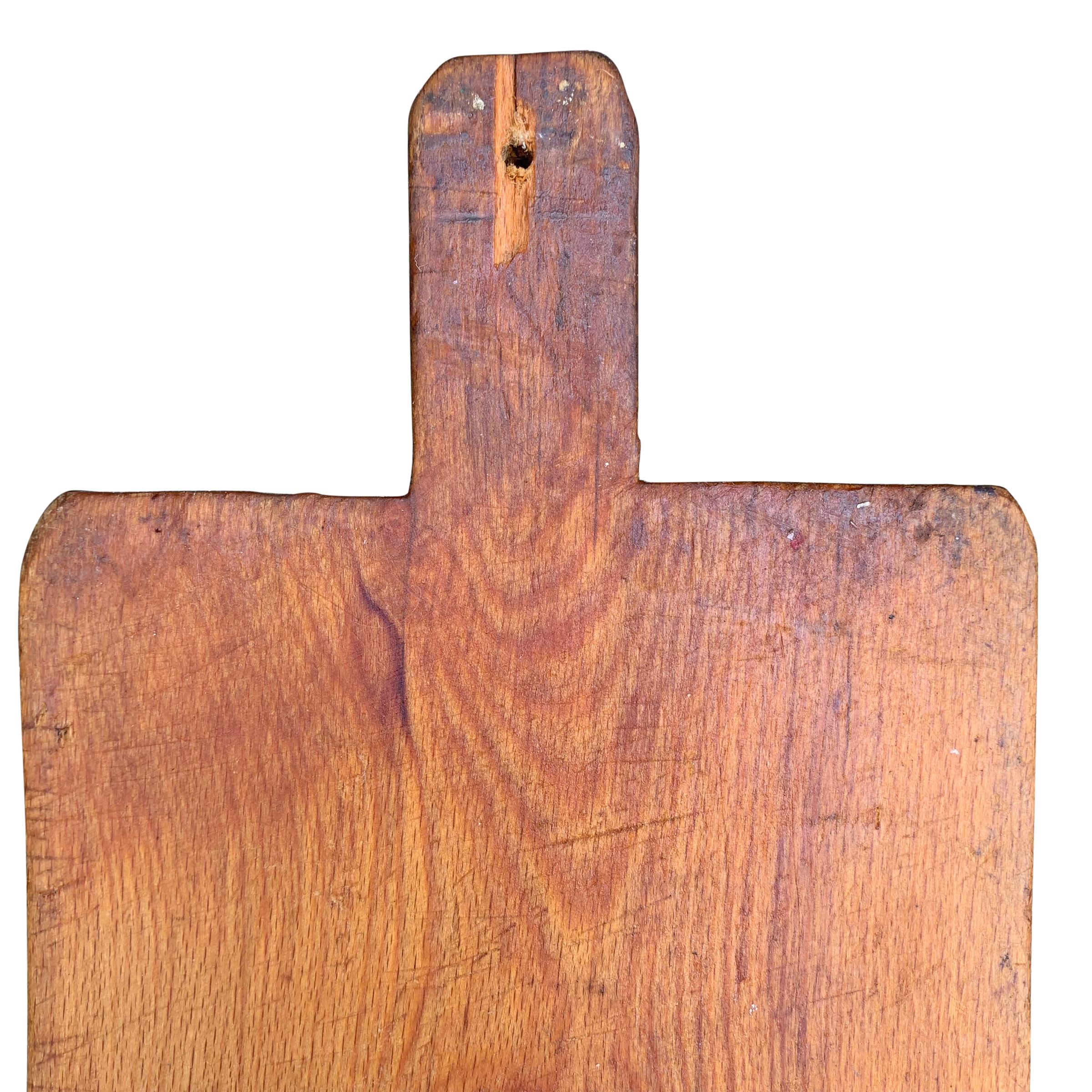 A wonderfully worn early 20th century French pine cutting board with a beautiful patina. All that’s missing is a selection of cheeses, charcuterie, and your guests.