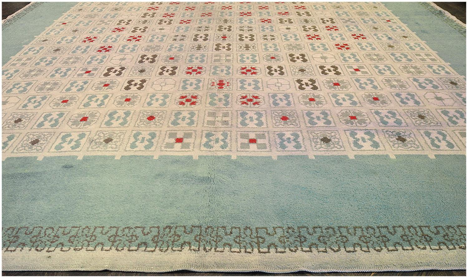 This traditional handwoven French Leleu deco rug has an overall eu-de-nil field with a profusion of delicate tiles checkered with alternating geometric icons, in a majestic turquoise green border with a complementary outlined geometric stripe