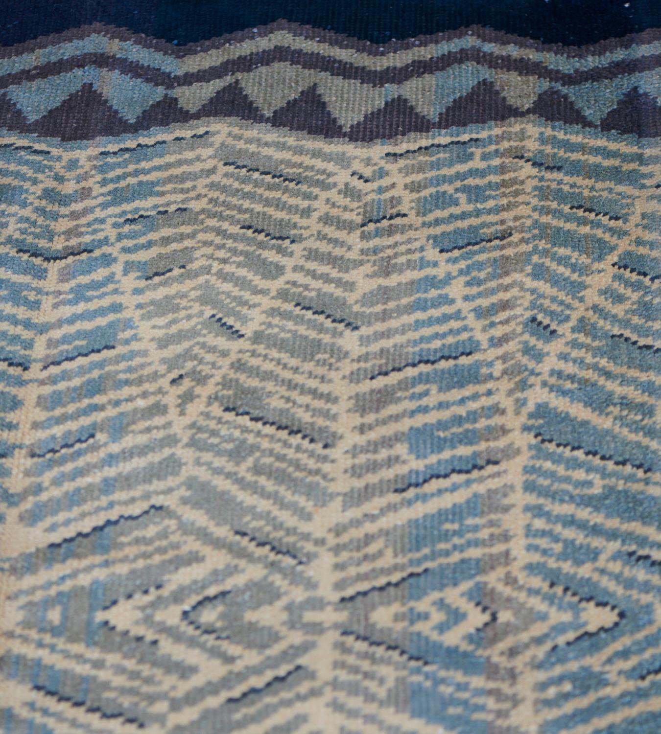 This vintage hand-woven French deco rug has a blue-gray field with overall design of delicate herringbone motif with prominent stylized distal chevron border.

European Deco rugs came at the beginning of the 20th century on the wave of rapid changes