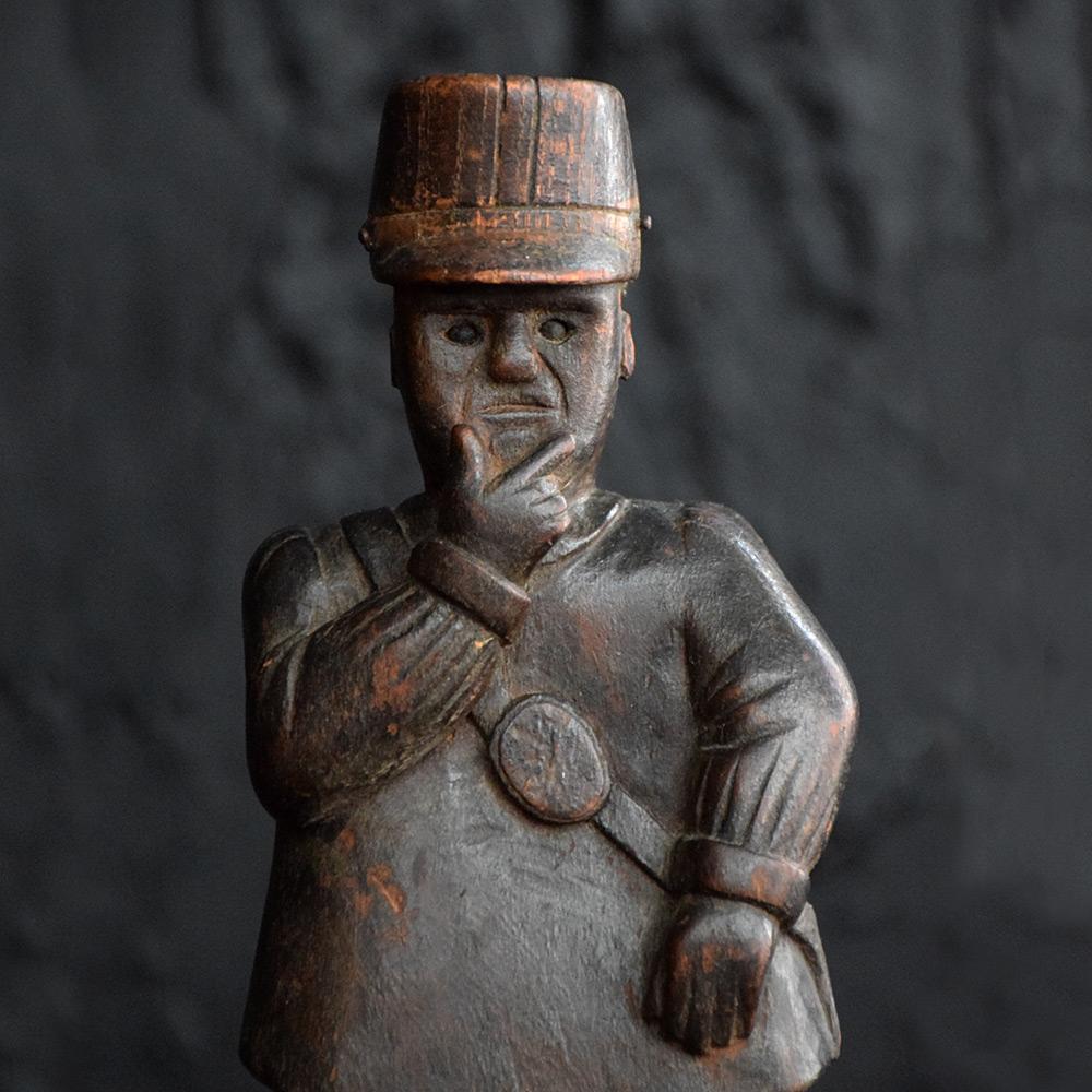 Early 20th century folk art model 

'EST-CE UN PIETON OU UNE VOITURE?' (IS IT A PEDESTRIAN OR A CAR?)

An Early 20th century French hand carved folk art model, depicting a police officer and his dog pulling over a small child in a walking frame,