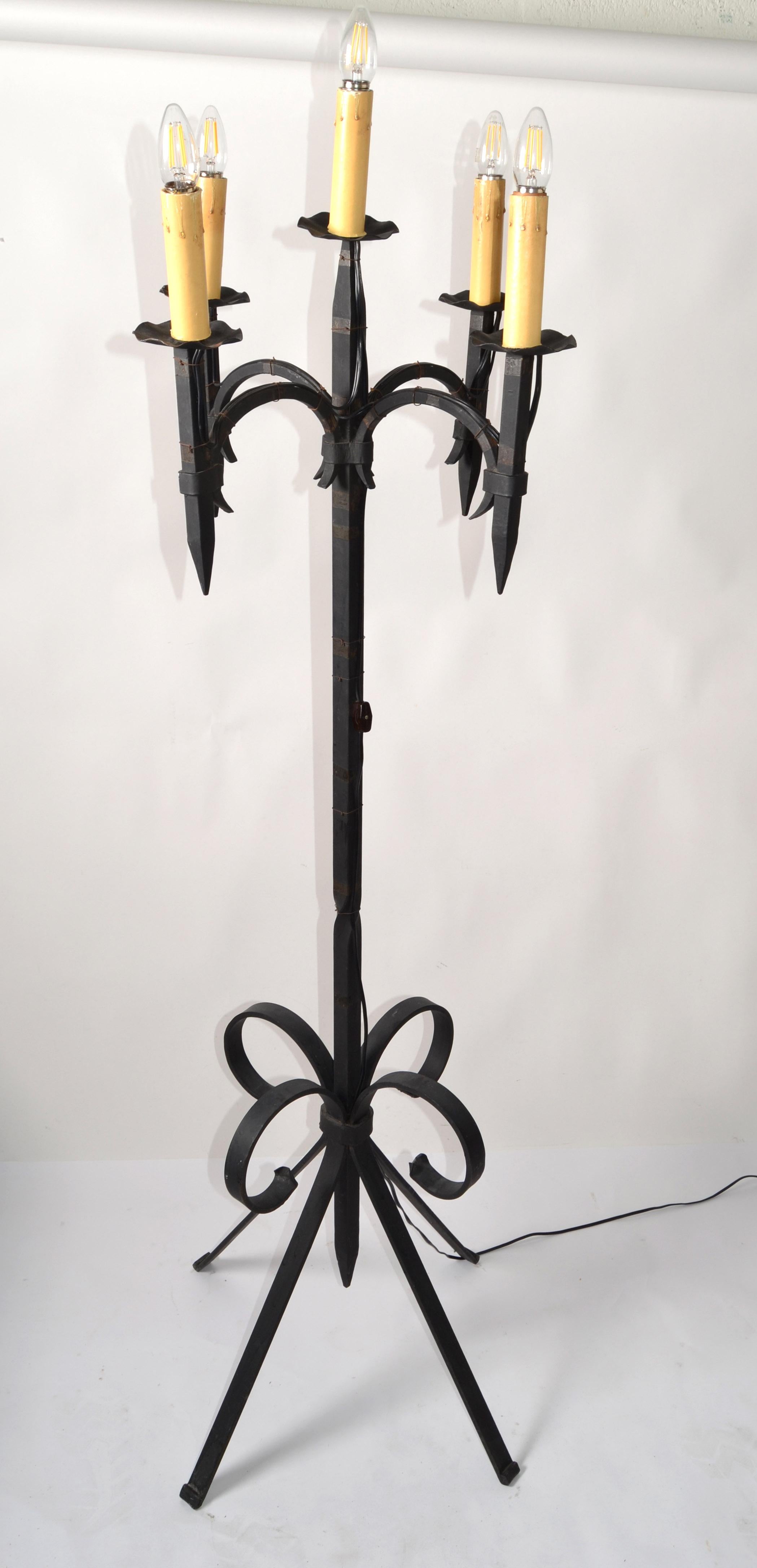 Early 20th century Gothic Style French forged wrought iron 5 light candelabra floor lamp.
US Rewiring and each takes a regular or LED Light bulb.
Has a cord switch attached to the twisted stem. 
Heavy floor lamp built to last for many more