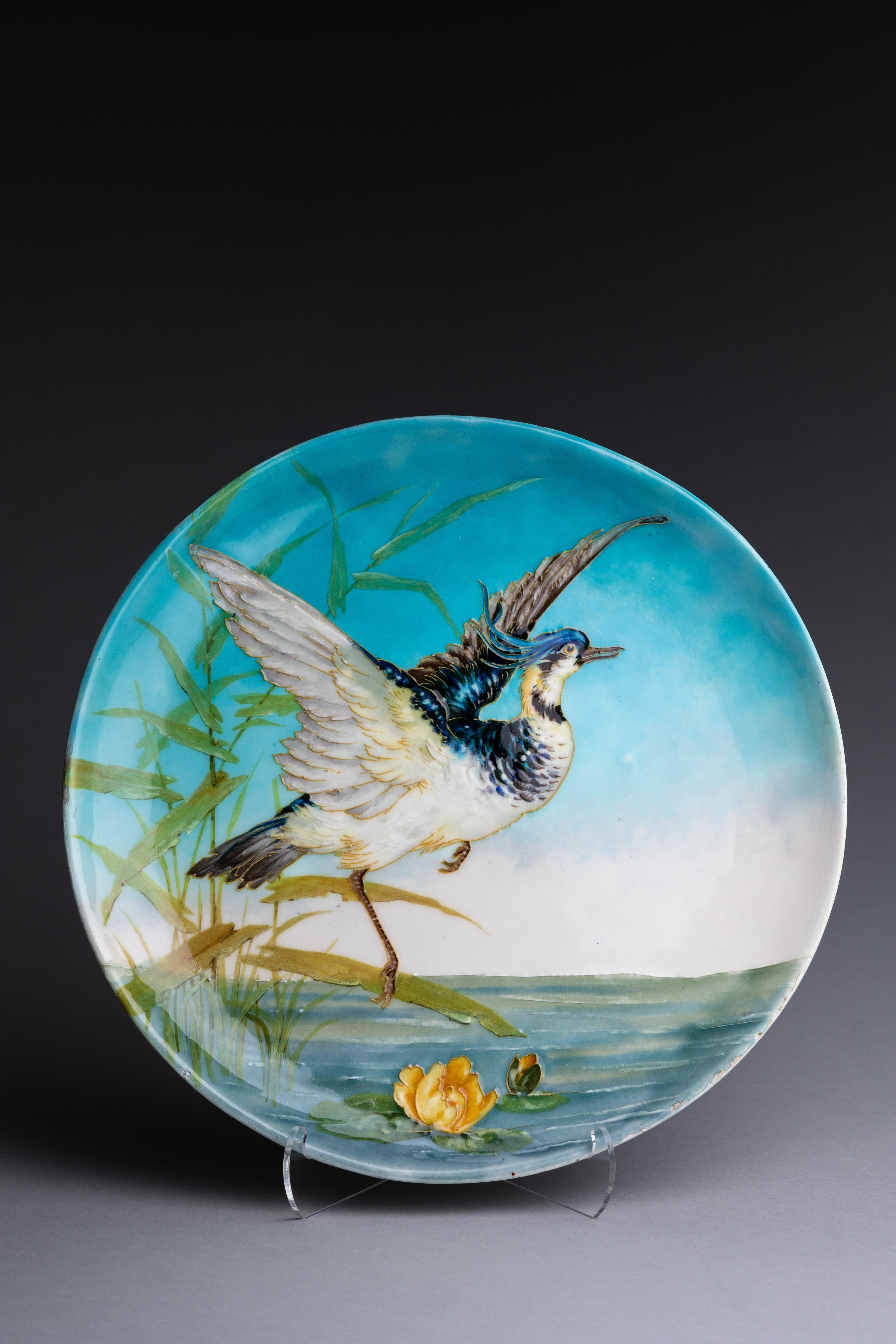 A French porcelain hand-painted plaque by Paul Milet created in the early 20th century.

This plaque, created by Sèvres ceramicist Paul Milet in the early 20th century, features a heron in flight over a marsh landscape. Milet's plaque highlights