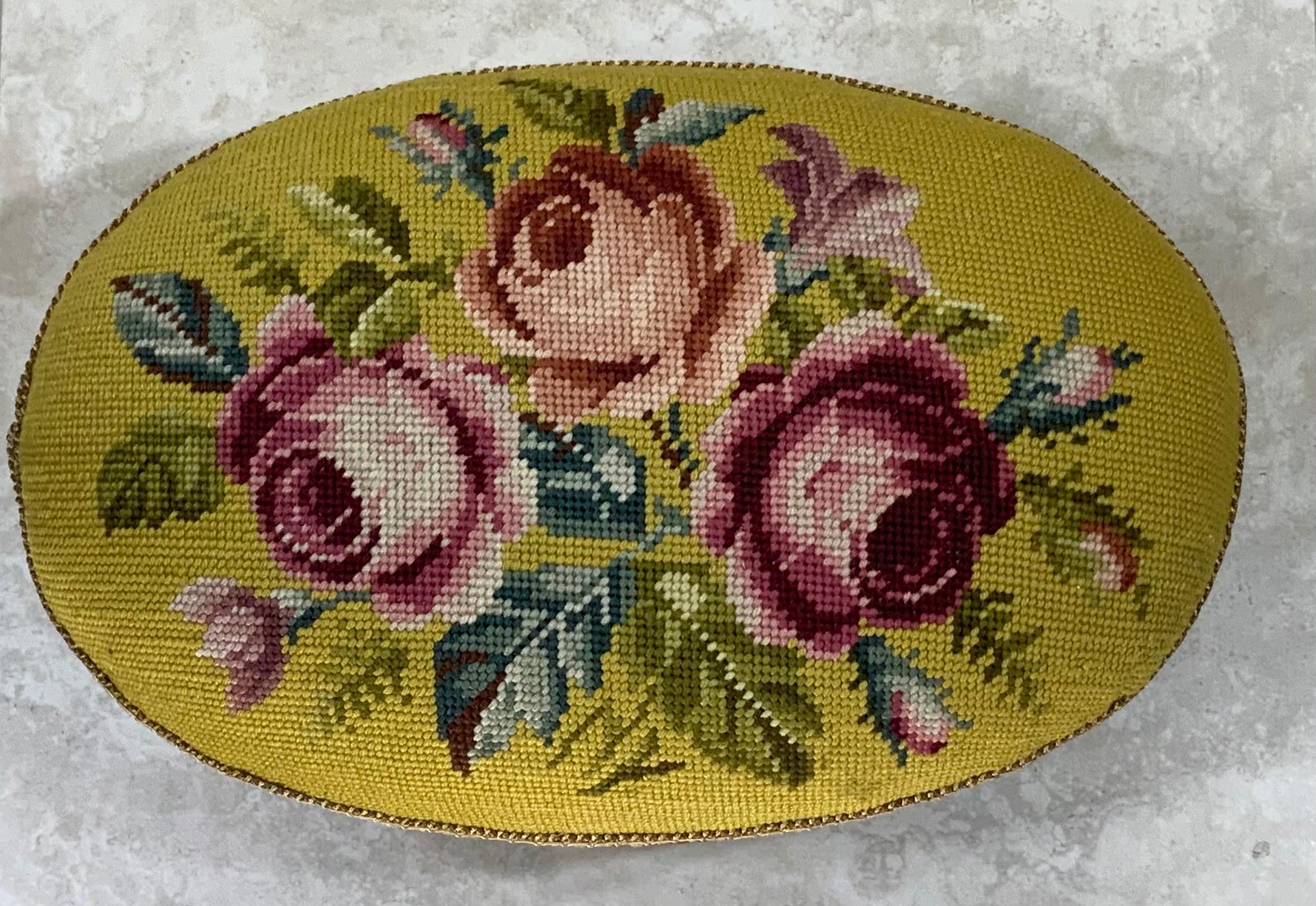 Beautiful accent piece for any room, hand carved wood footstool upholstered with beautiful floral Motif French needlepoint.