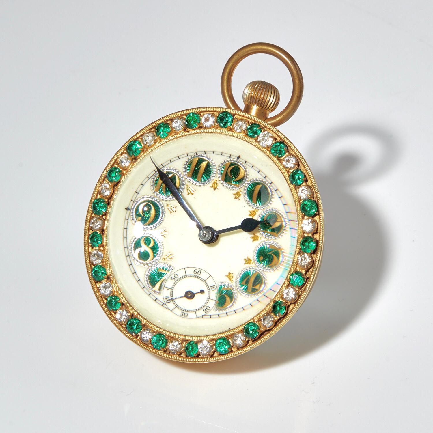 The stunning green translucent enamel numerals and surmounted past bezel, sets this piece apart. The piece is in excellent condition.

Height of actual clock 2 3/4” add 1/4 “ for winder D 2 1/4”.
