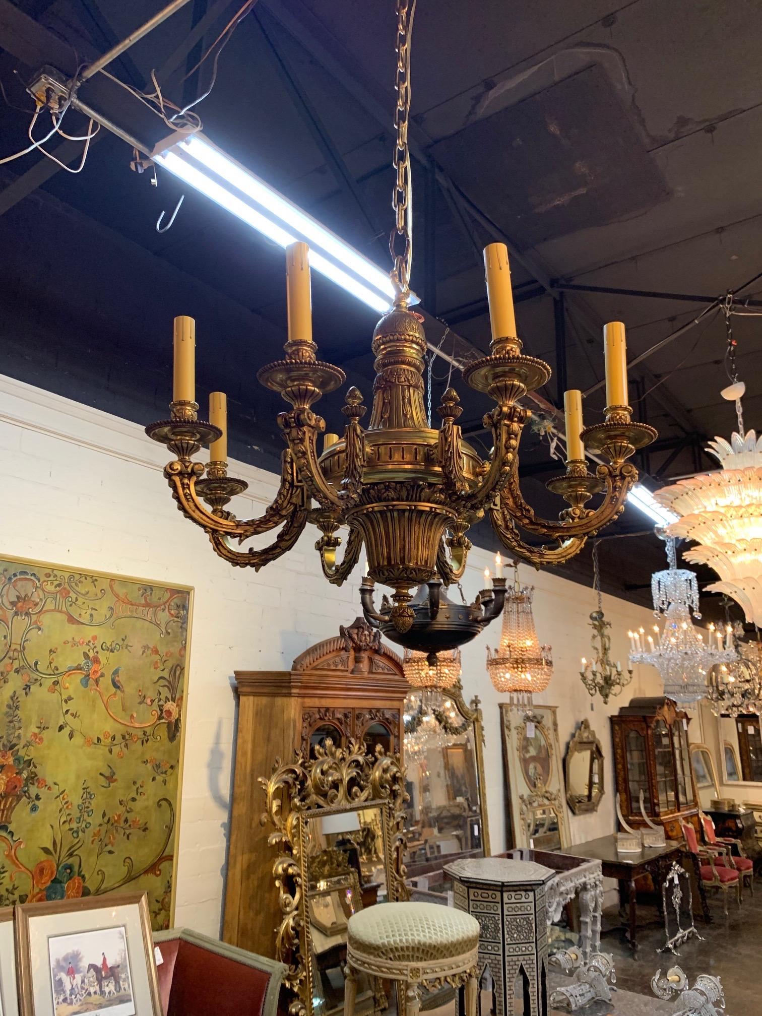 Exceptional 20th century French gilt bronze chandelier with 8-lights. Fabulous decorative details make this fixture stand out. Lovely!